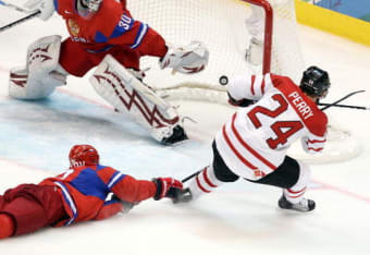 Detroit Red Wing goalie Dominik Hasek, of the Czech Republic (39), is  unable to stop a goal from Chicago Blackhawks' Patrick Sharp (10) during  the third period of an NHL hockey game