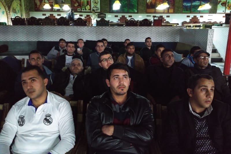 The Palestina Blanca watch intently as Real Madrid play.