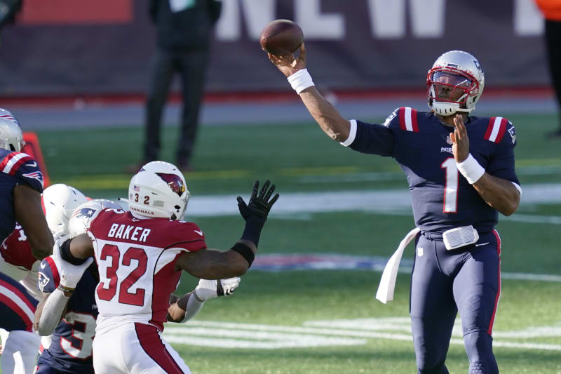New England Patriots quarterback Cam Newton (1) passes under pressure from Arizona Cardinals safety Budda Baker (32) in the first half of an NFL football game, Sunday, Nov. 29, 2020, in Foxborough, Mass. (AP Photo/Elise Amendola)