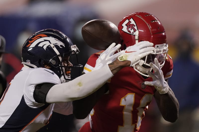Kansas City Chiefs wide receiver Tyreek Hill (10) tries to catch a pass as Denver Broncos cornerback A.J. Bouye (21) defends in the first half of an NFL football game in Kansas City, Mo., Sunday, Dec. 6, 2020. (AP Photo/Charlie Riedel)