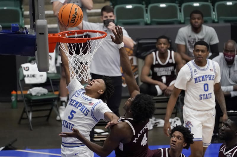 Memphis guard Boogie Ellis (5) gets past Mississippi State guard Cameron Matthews (4) for a shot in the first half of an NCAA college basketball championship game in the NIT, Sunday, March 28, 2021, in Frisco, Texas. (AP Photo/Tony Gutierrez)