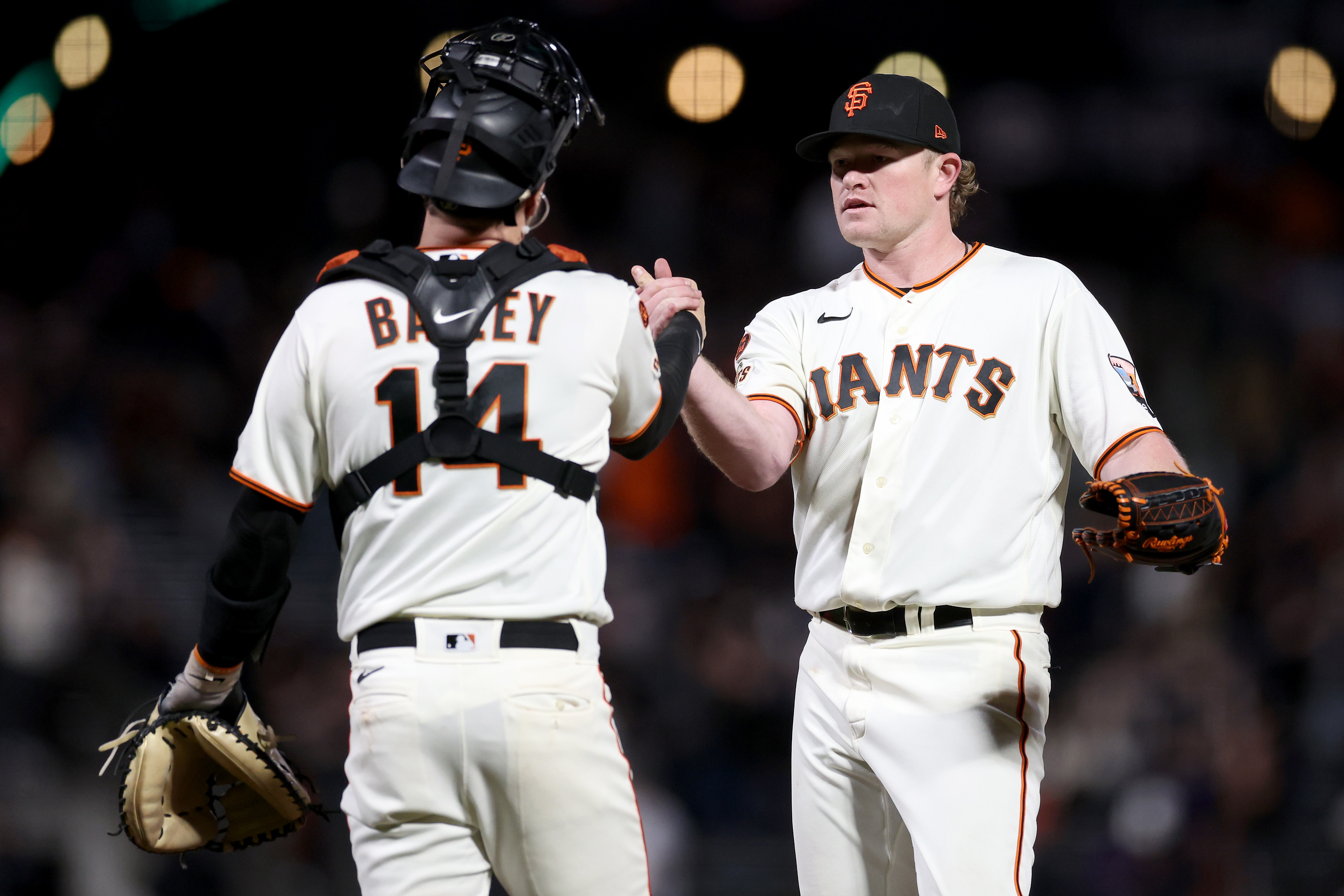 San Francisco Giants catcher Buster Posey hugs pitcher Brian Wilson after  they defeated the Philadelphia Phillies 3-2 in game 6 of the NLSC between  the San Francisco Giants and the Philadelphia Phillies