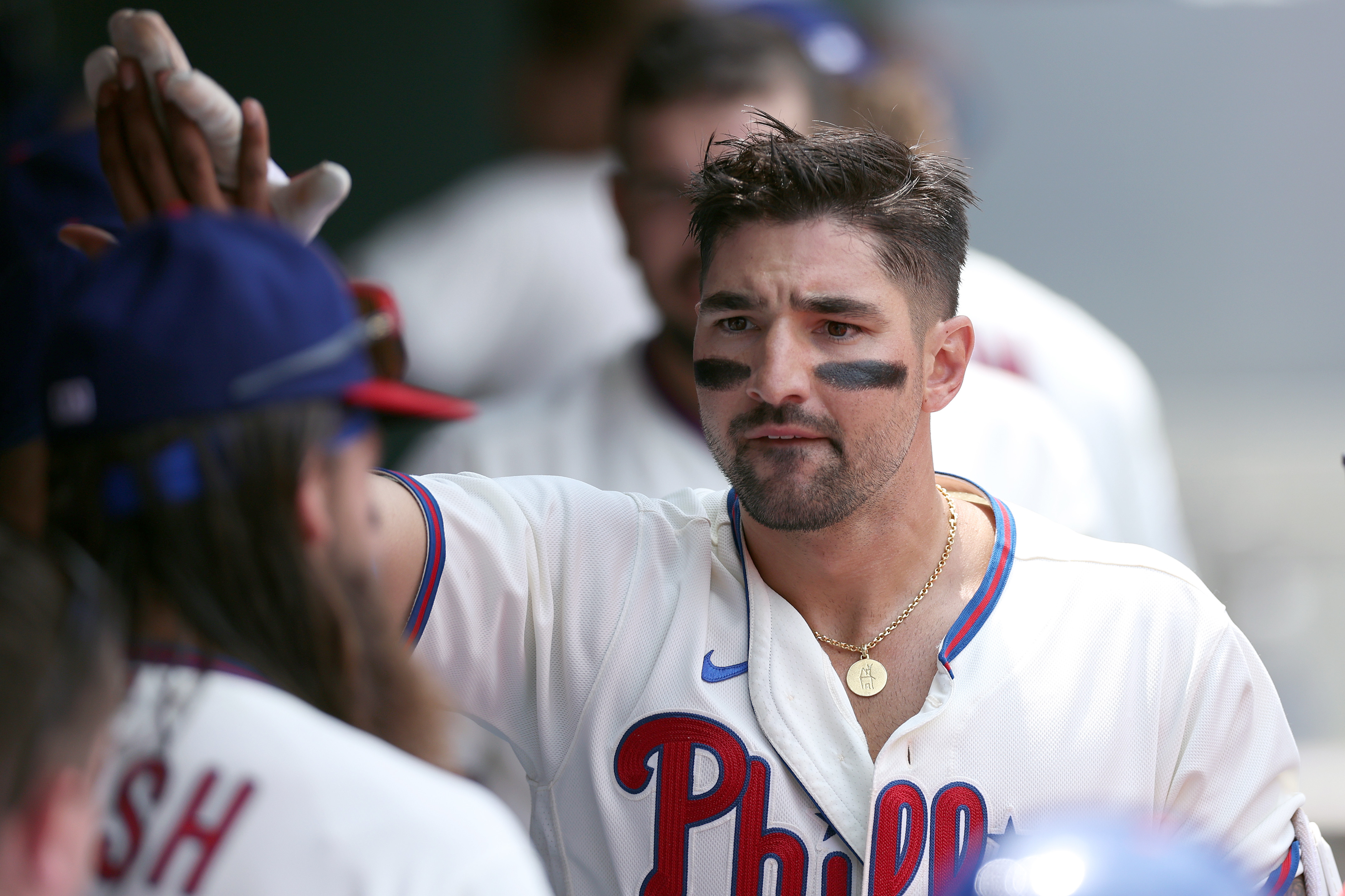 Reds outfielder Nick Castellanos and his son Liam sell shirts for