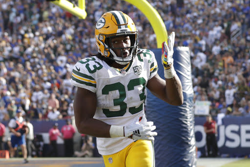 NFL on ESPN - Aaron Jones is wearing a necklace with a photo of him and his  late father before the Green Bay Packers' SNF game 