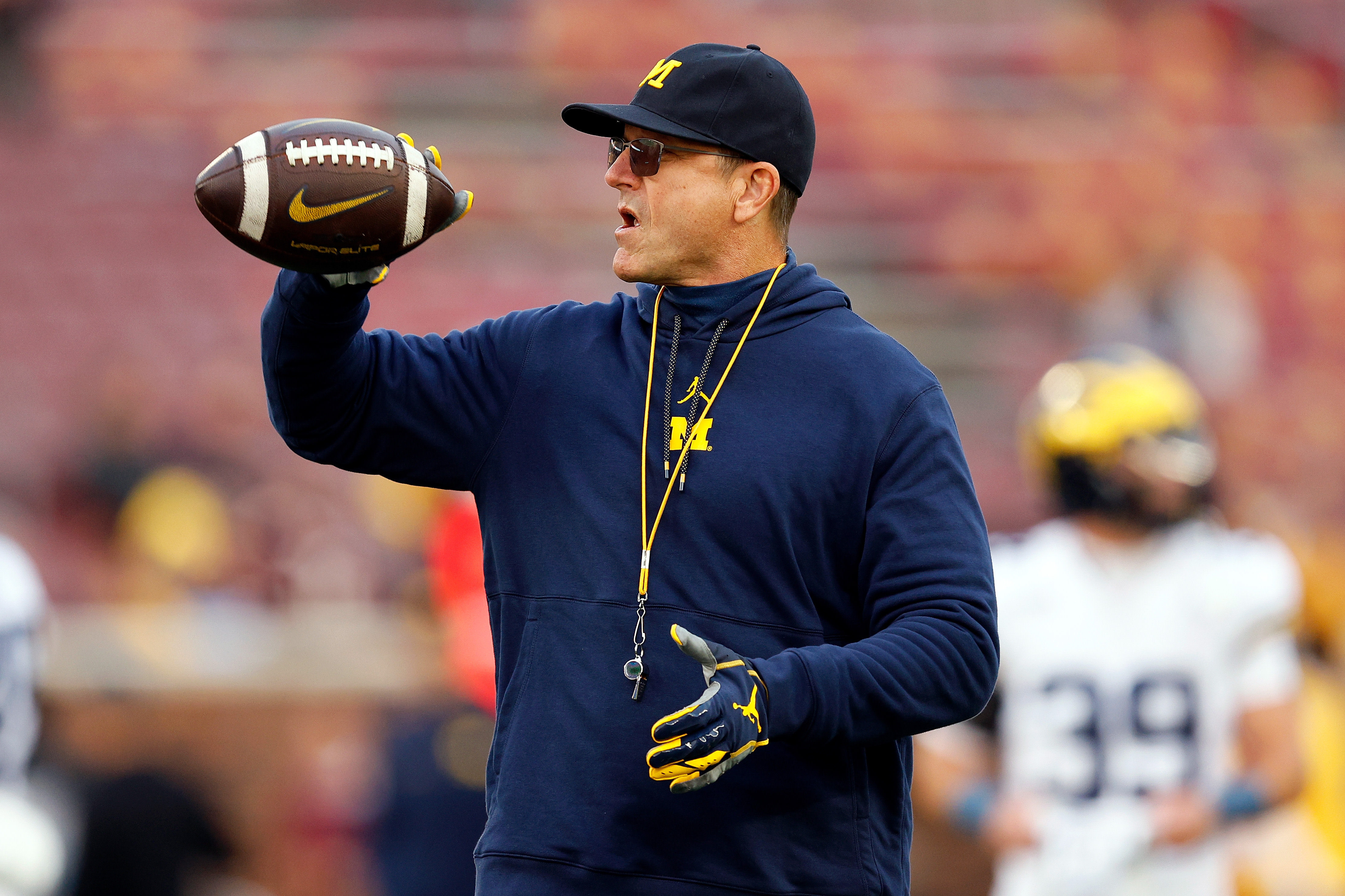 Michigan football's J.J. McCarthy warms up in 'Free Harbaugh' shirt