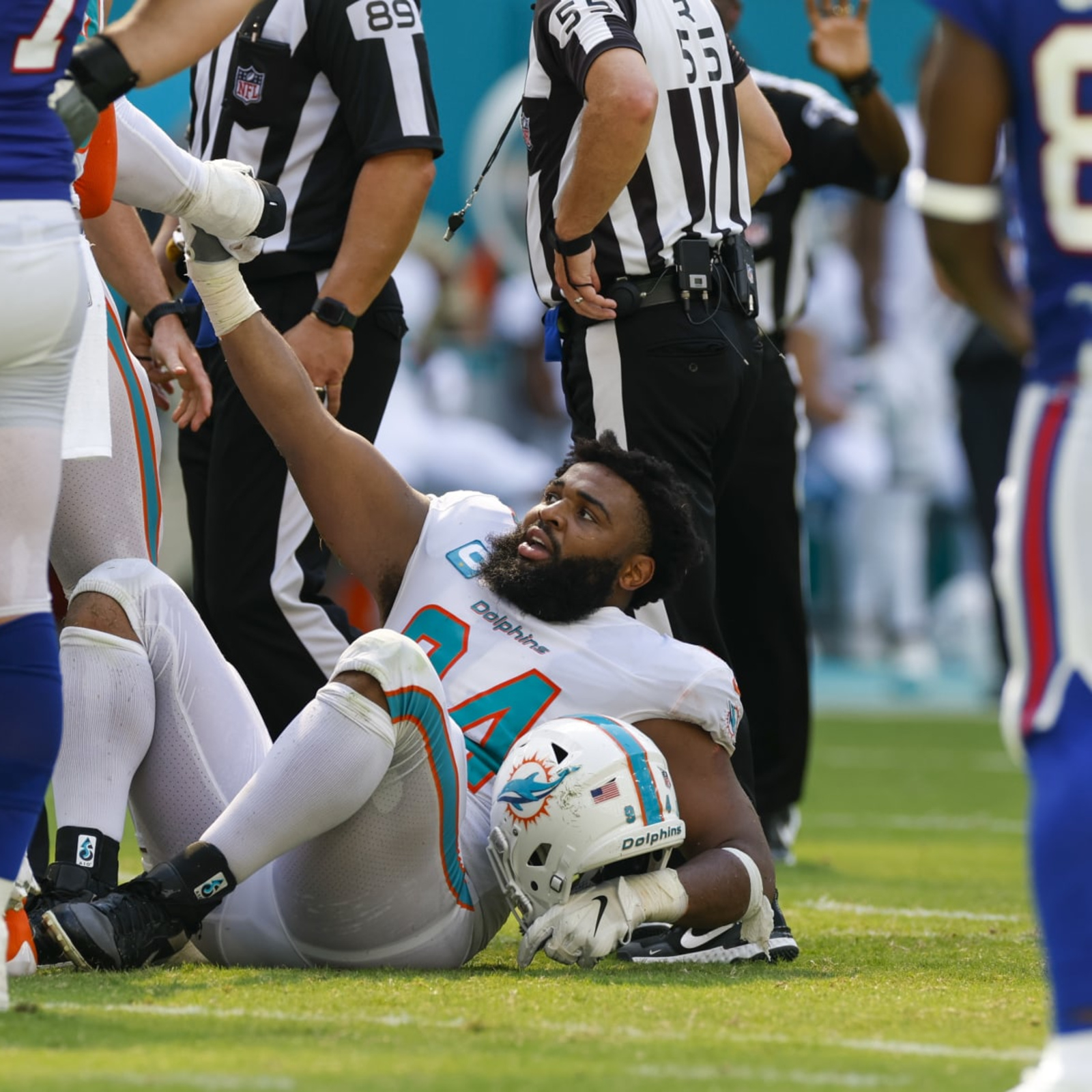 Miami Dolphins defensive tackle Christian Wilkins (94) yells as he runs  onto the field before the start of an NFL football game against the Buffalo  Bills, Sunday, Sept. 25, 2022, in Miami