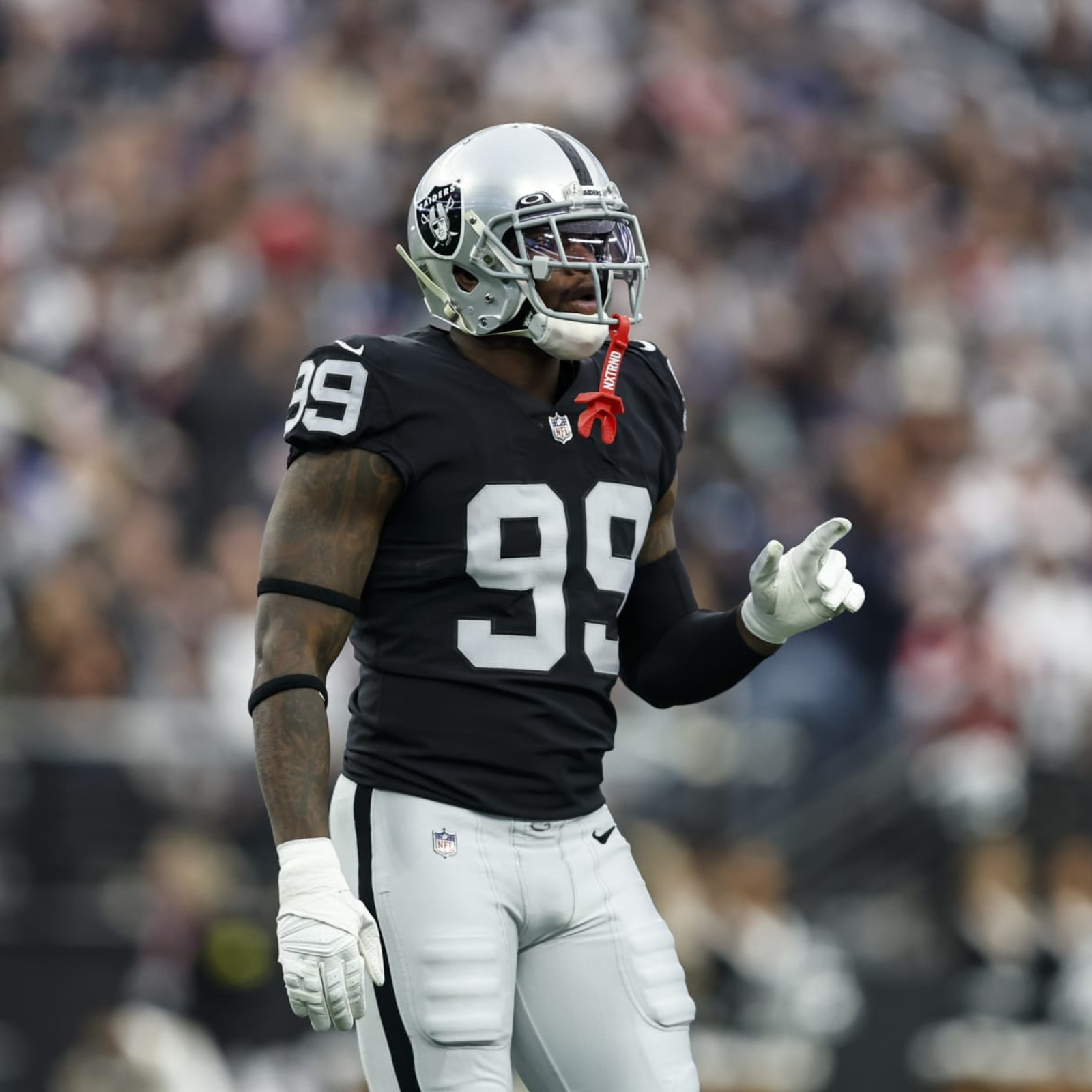 Raiders defensive end Clelin Ferrell (99) warms up on the field before an  NFL playoff game agai …