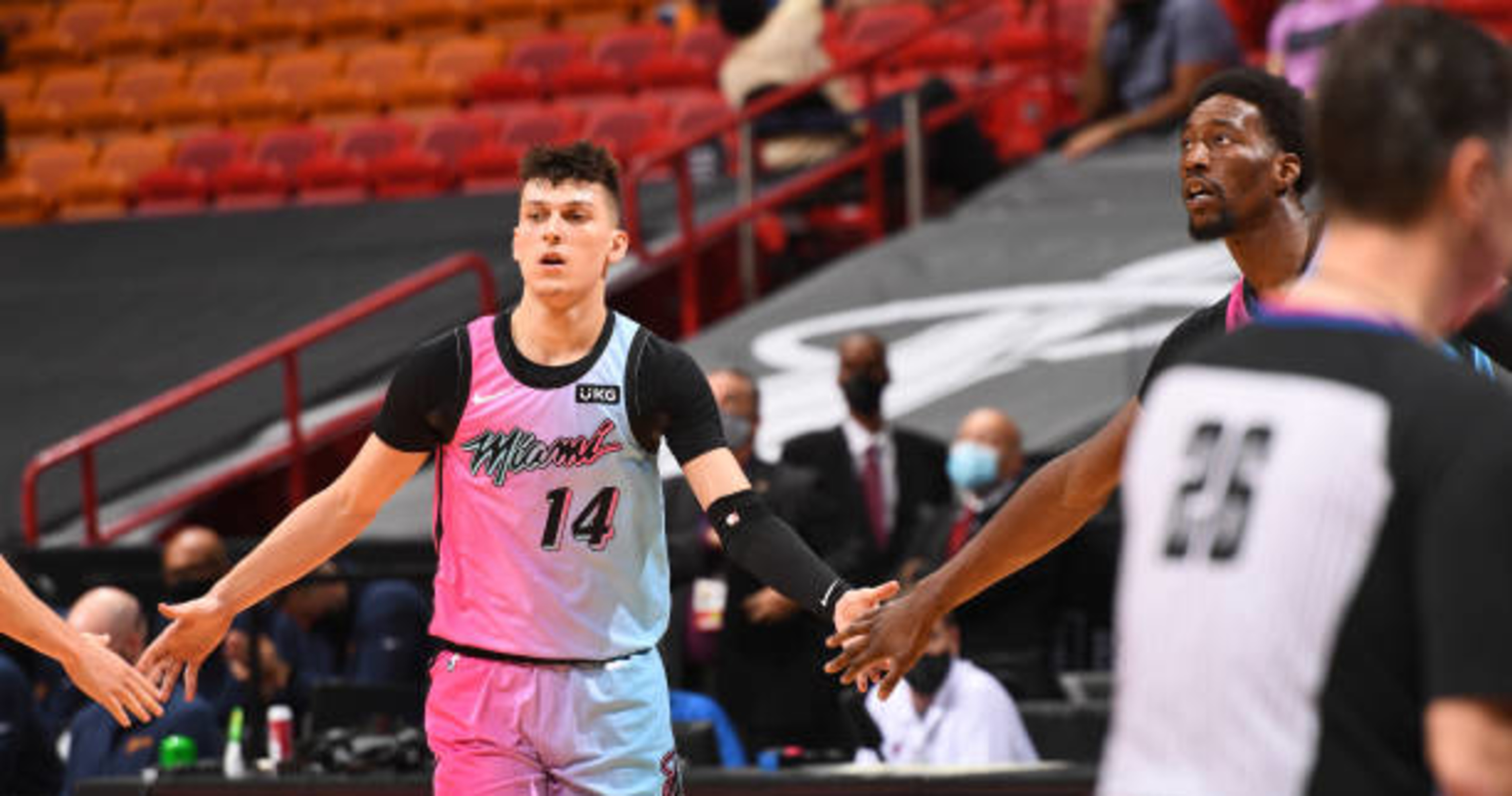 Tyler Herro wears beach outfit on bench during Game 5