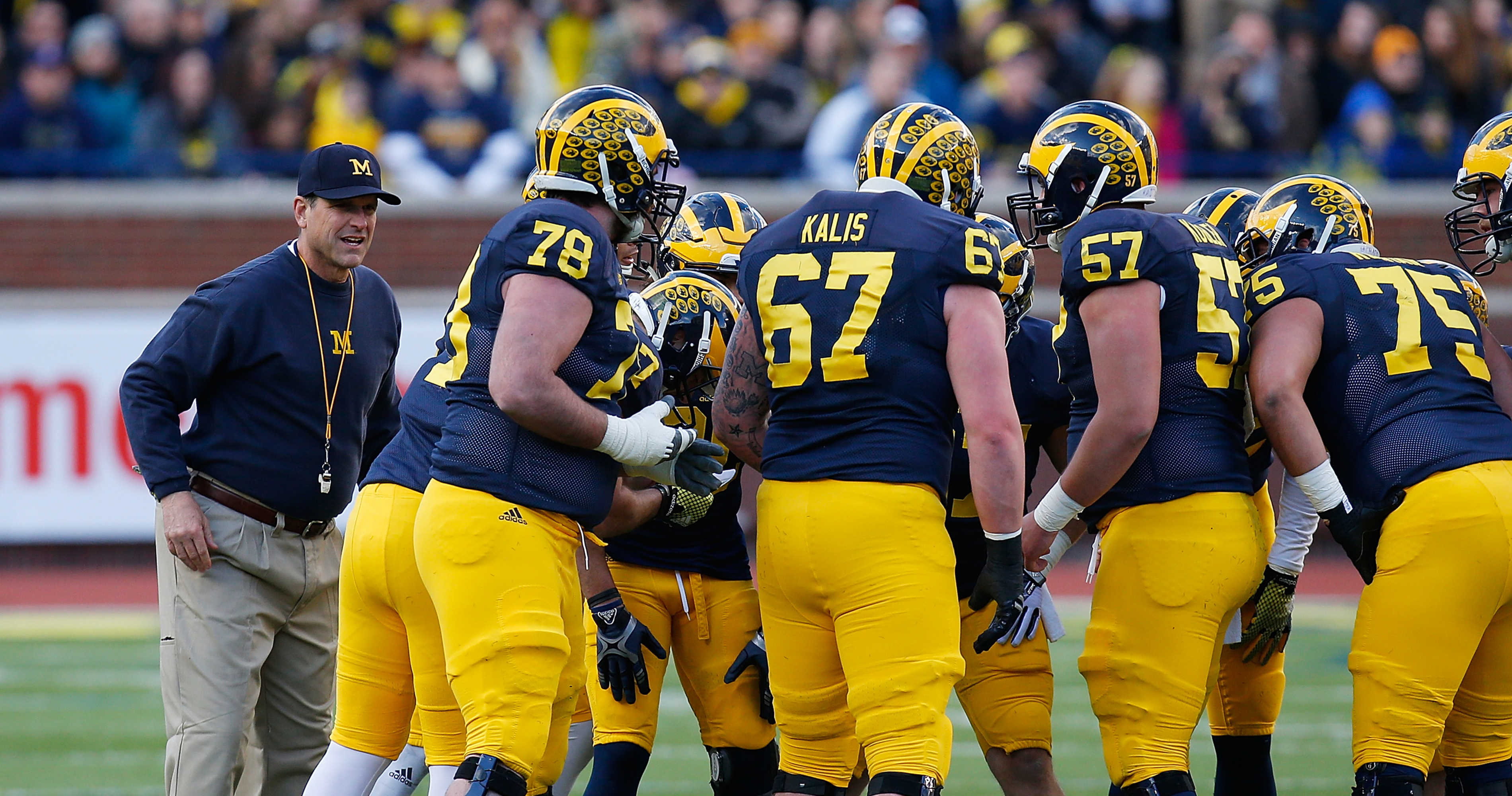 M Den selling Michigan football jerseys with players' names on the back 