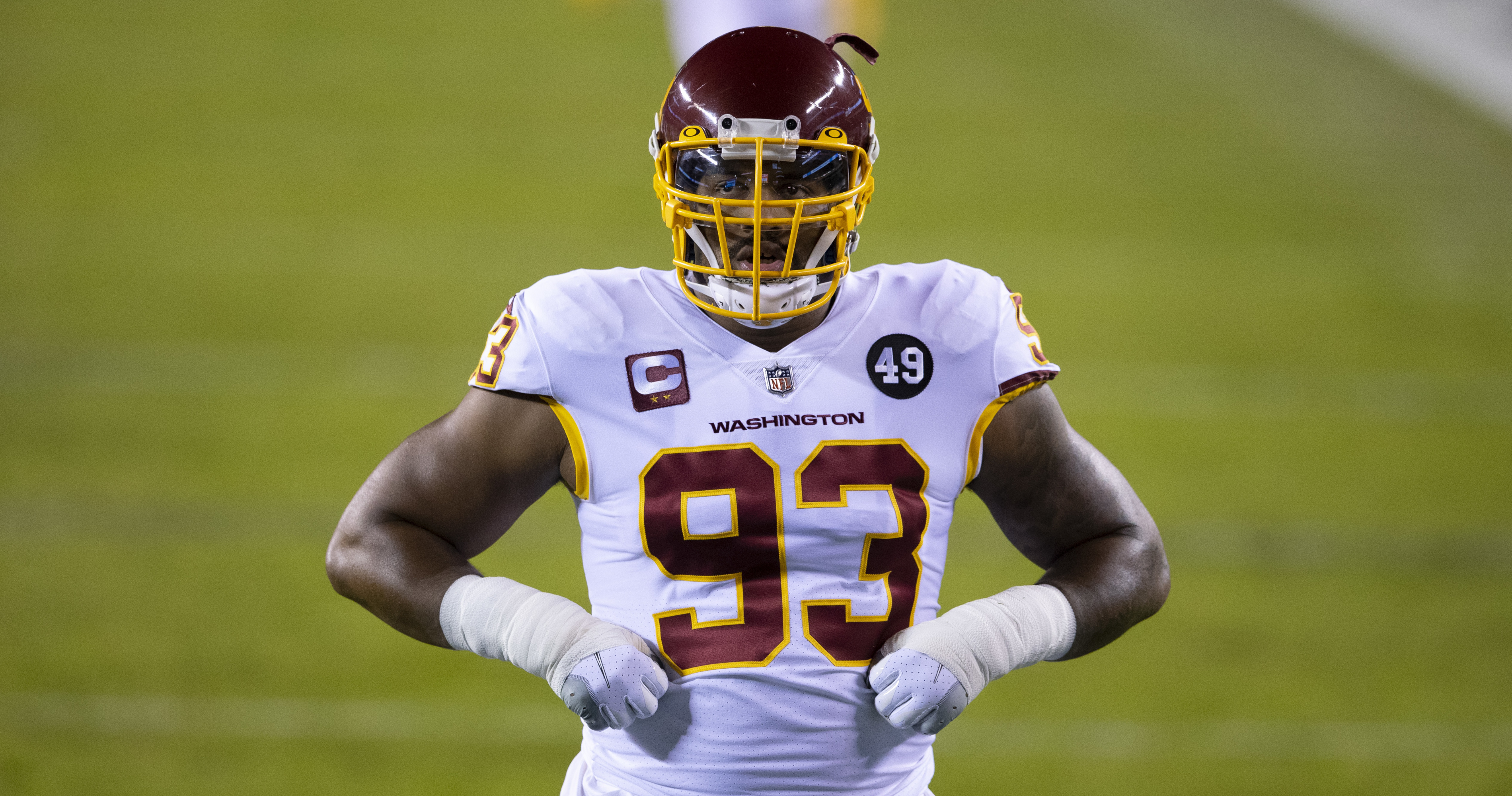 Jonathan Allen boots away Eagles kicker's football during warmups 