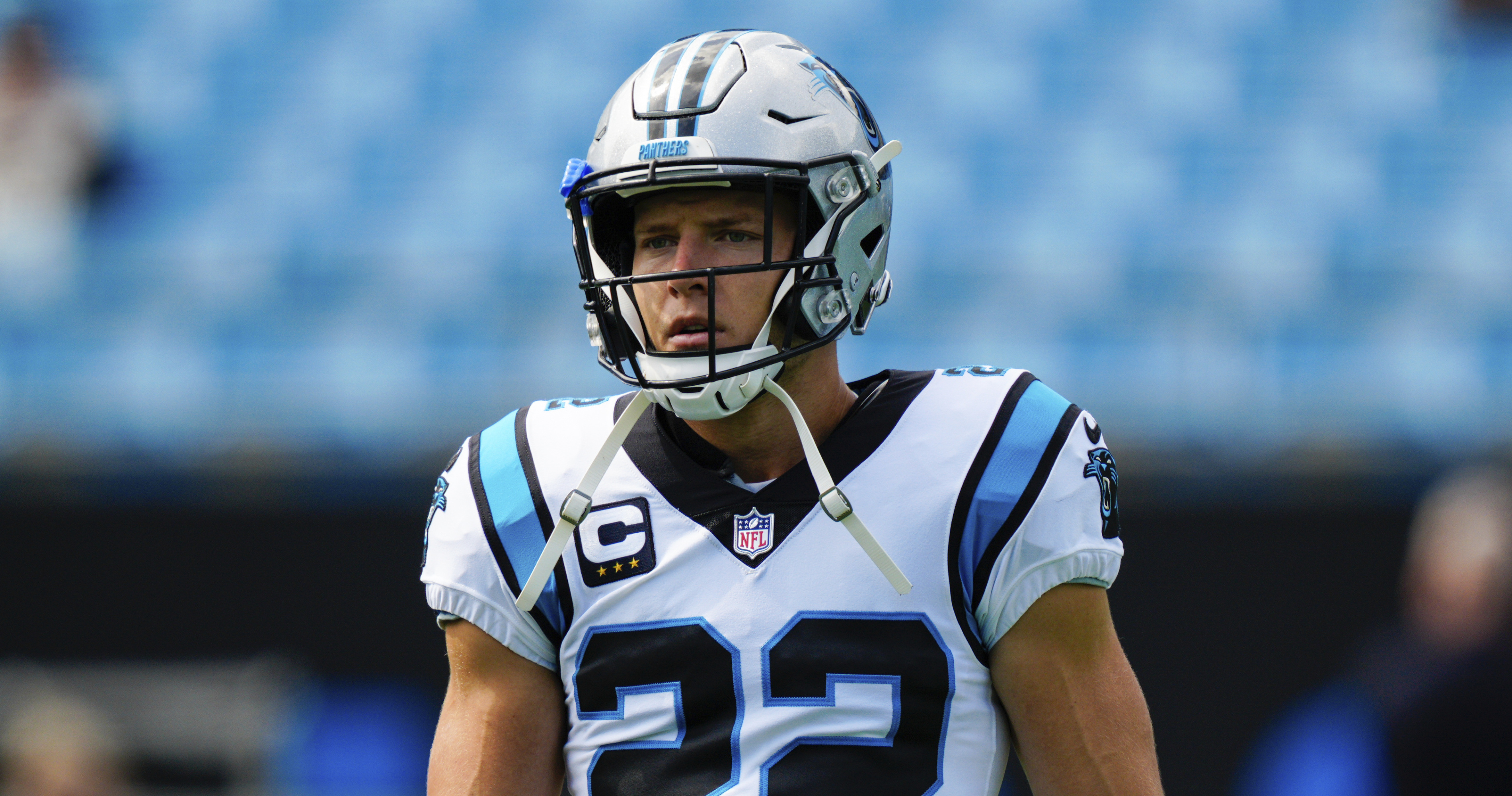 Christian McCaffrey of the Carolina Panthers jumps over Tre