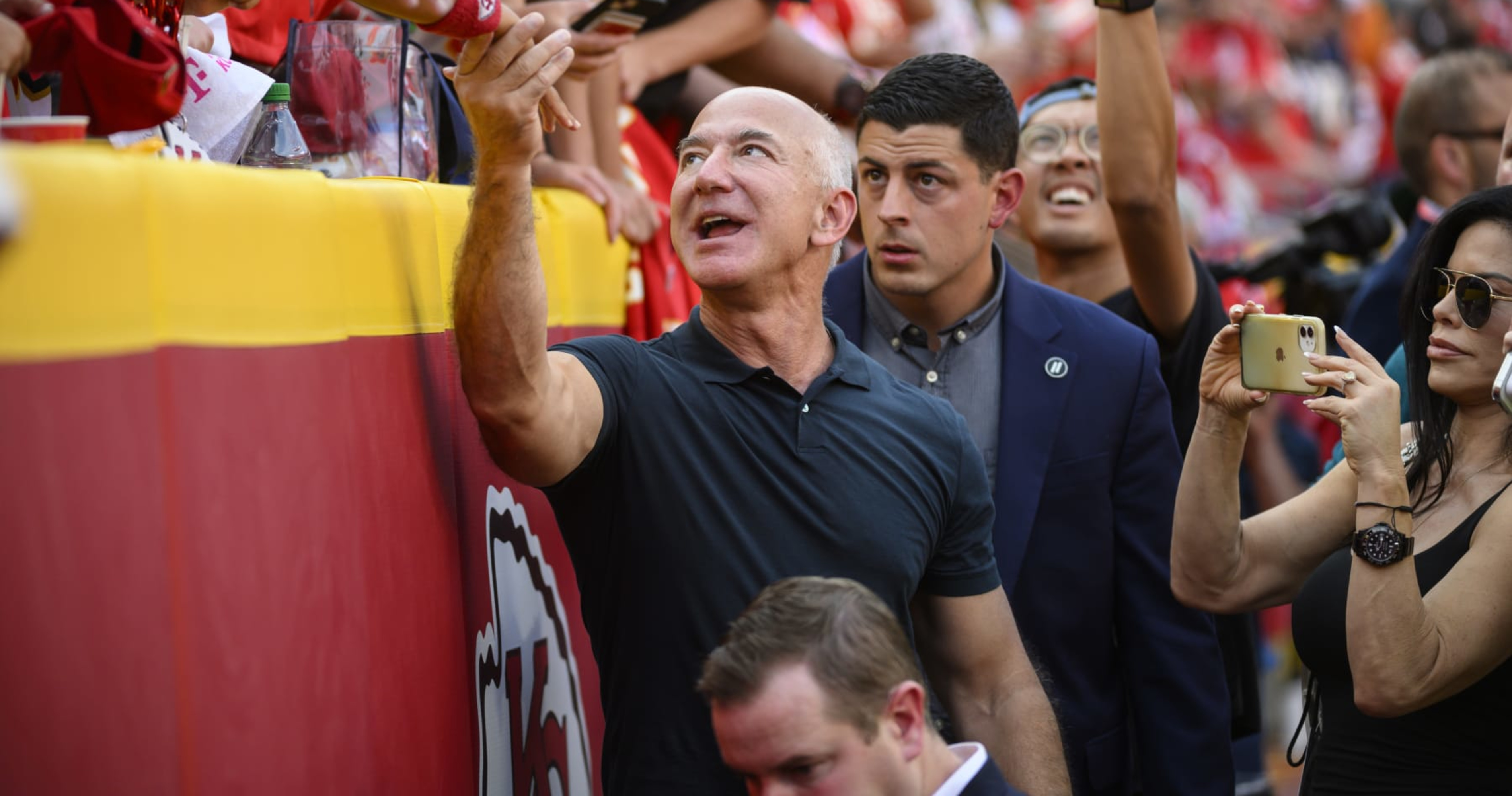 founder Jeff Bezos, left, talks with Kansas City Chiefs