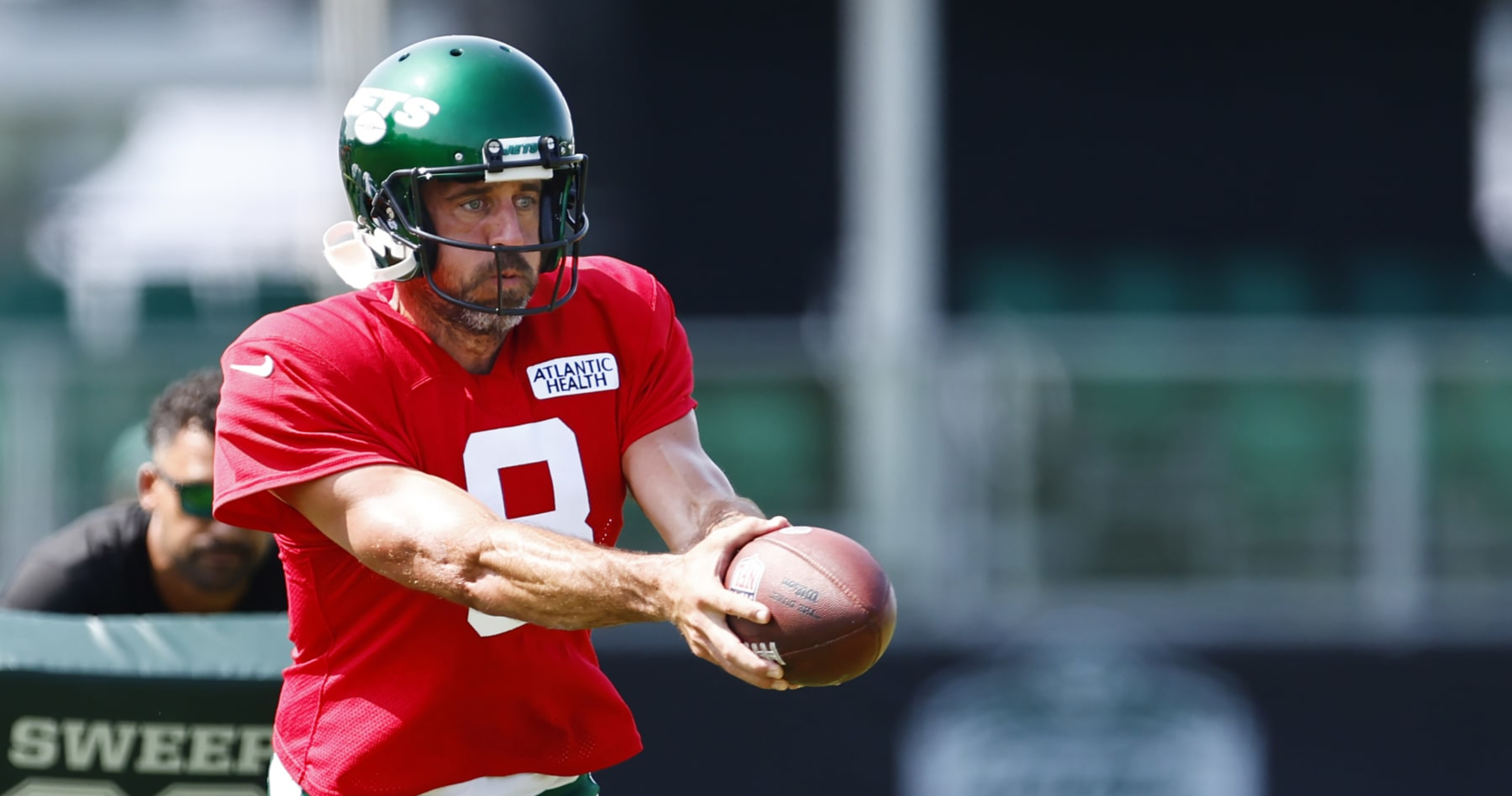 New York Jets quarterback Aaron Rodgers (8) stands on the sidelines during  the first half of an NFL preseason football game against the New York Giants,  Saturday, Aug. 26, 2023, in East