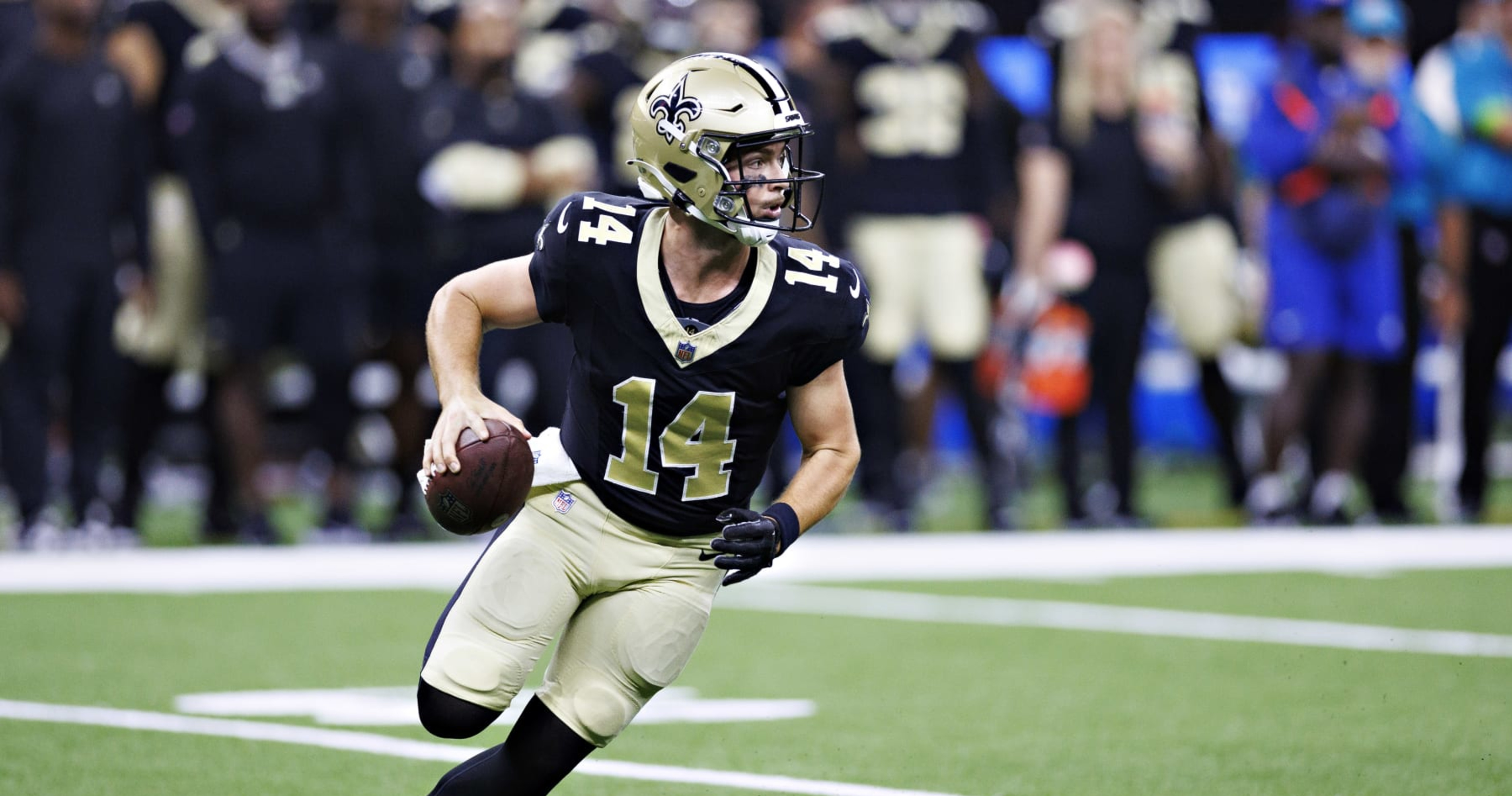 New Orleans Saints quarterback Jake Haener (14) runs through