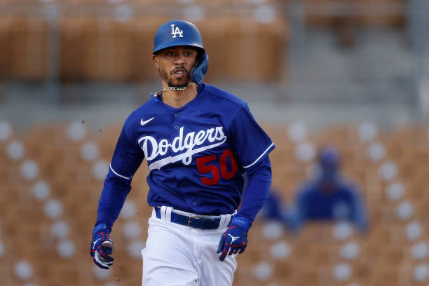 GLENDALE, ARIZONA - MARCH 10: Mookie Betts #50 of the Los Angeles Dodgers runs to first base on a ground ball during the first inning of the MLB spring training game against the Arizona Diamondbacks at Camelback Ranch on March 10, 2021 in Glendale, Arizona. (Photo by Christian Petersen/Getty Images)