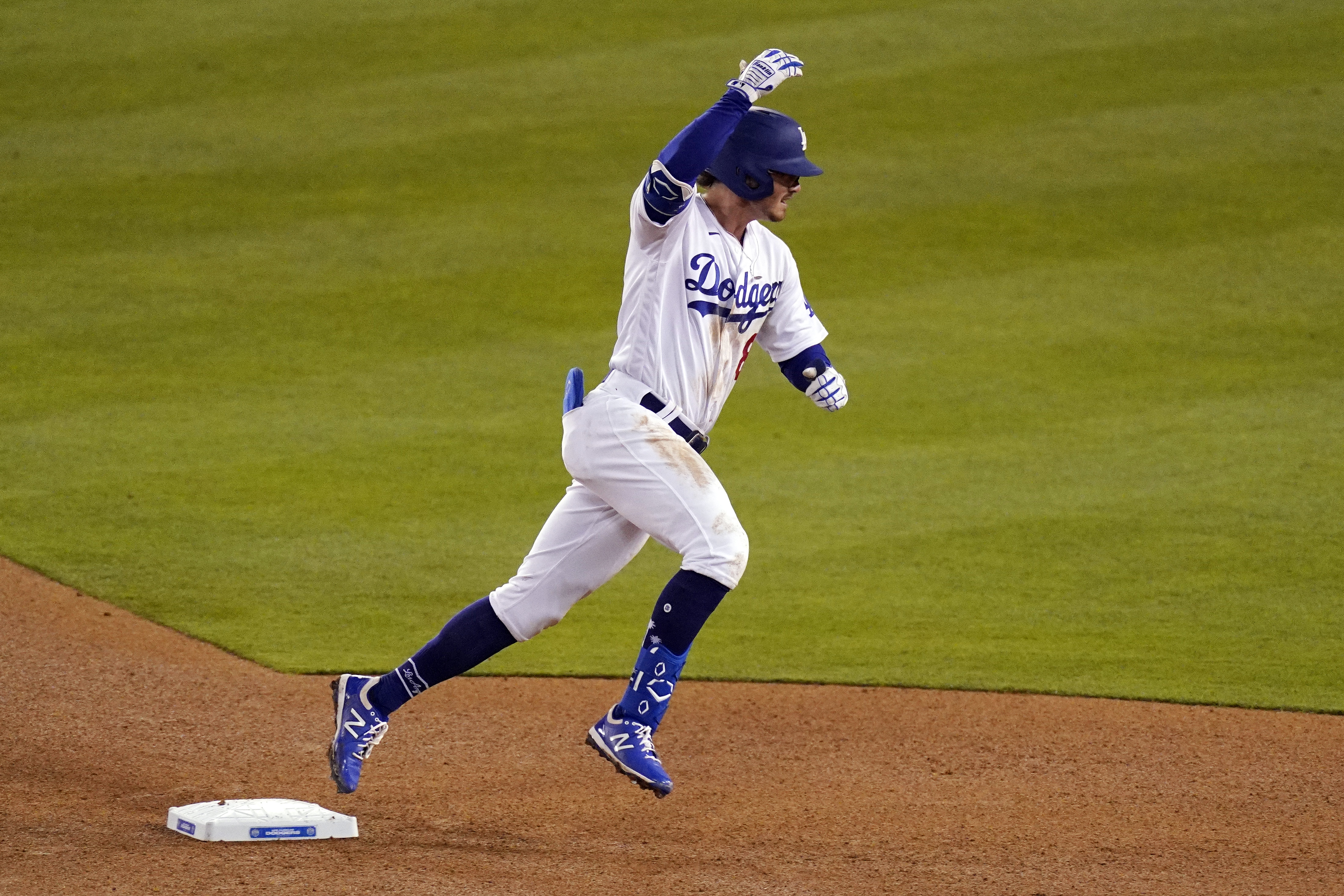 Los Angeles Dodgers' Zach McKinstry gestures towards his dugout as the rounds second after hitting a solo home run during the eighth inning of a baseball game against the Colorado Rockies Wednesday, April 14, 2021, in Los Angeles. (AP Photo/Mark J. Terrill)