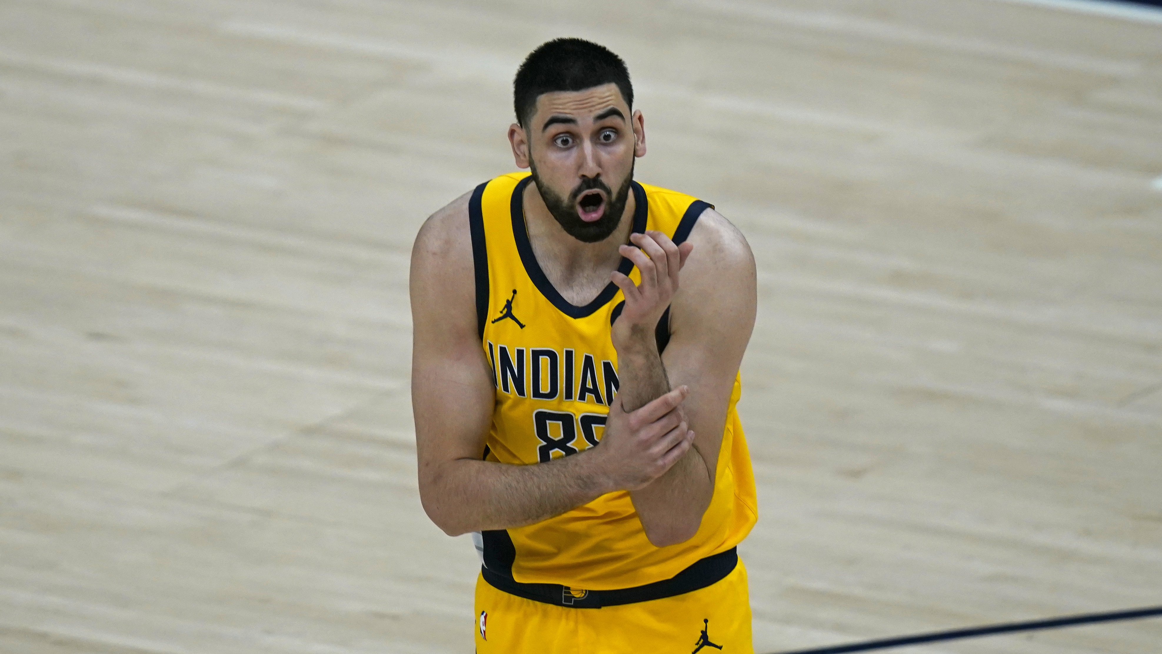 Indiana Pacers center Goga Bitadze reacts after fouling Utah Jazz center Rudy Gobert in the first half during an NBA basketball game against the Utah Jazz Friday, April 16, 2021, in Salt Lake City. (AP Photo/Rick Bowmer)