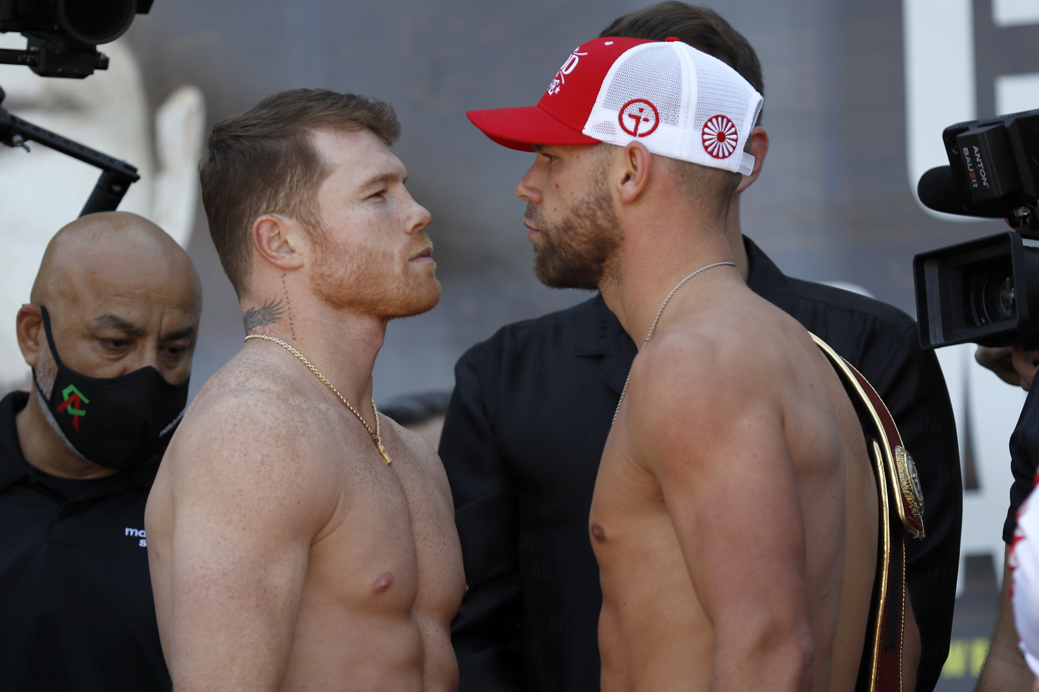 Canelo Alvarez, front left, and Billy Joe Saunders, right pose for a face off after their weigh-ins on Friday, May 7, 2021, in Arlington, Texas. Alvarez and Saunders fight on Saturday, May 8, 2021, for the unified super middleweight world championship. (AP Photo/Roger Steinman)