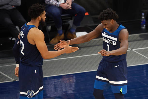 MINNEAPOLIS, MINNESOTA - APRIL 26: Karl-Anthony Towns #32 and Anthony Edwards #1 of the Minnesota Timberwolves celebrate after the game against the Utah Jazz at Target Center on April 26, 2021 in Minneapolis, Minnesota. The Timberwolves defeated the Jazz 105-104. NOTE TO USER: User expressly acknowledges and agrees that, by downloading and or using this Photograph, user is consenting to the terms and conditions of the Getty Images License Agreement (Photo by Hannah Foslien/Getty Images)