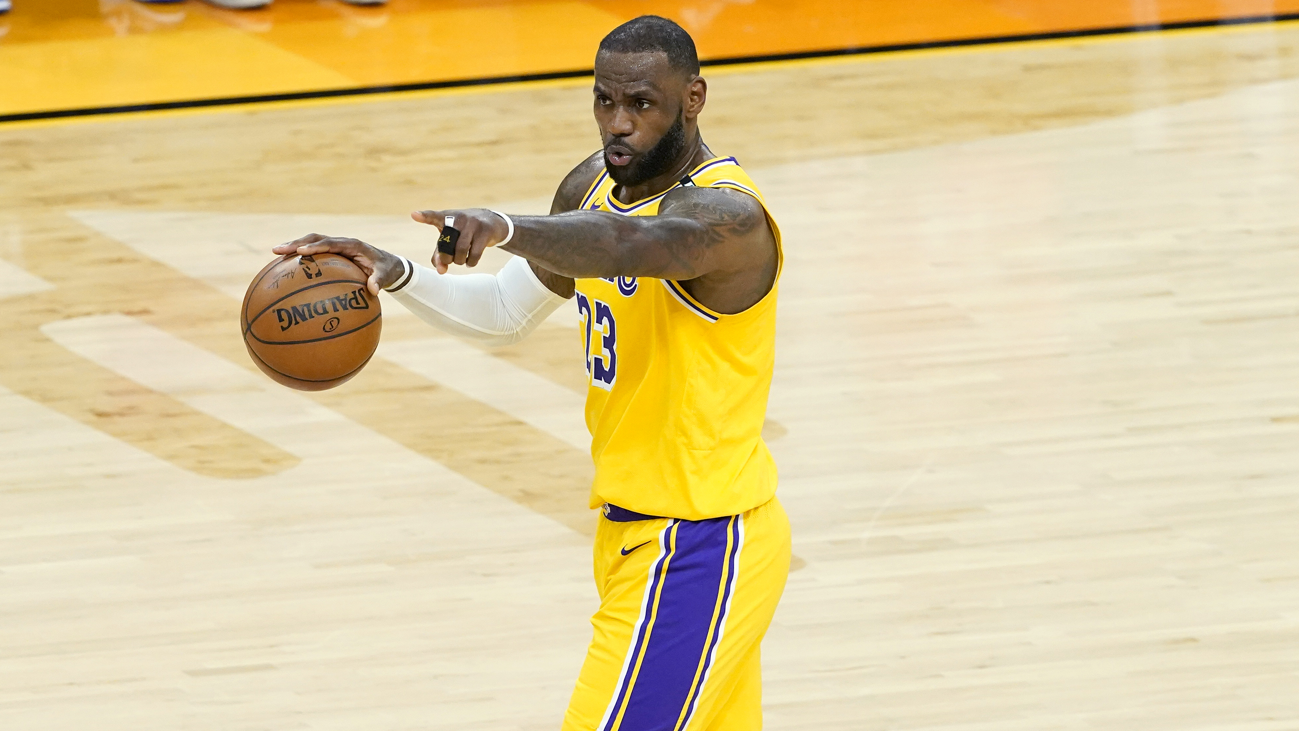 Los Angeles Lakers forward LeBron James (23) calls a play during the first half of Game 5 of an NBA basketball first-round playoff series against the Phoenix Suns, Tuesday, June 1, 2021, in Phoenix. (AP Photo/Matt York)
