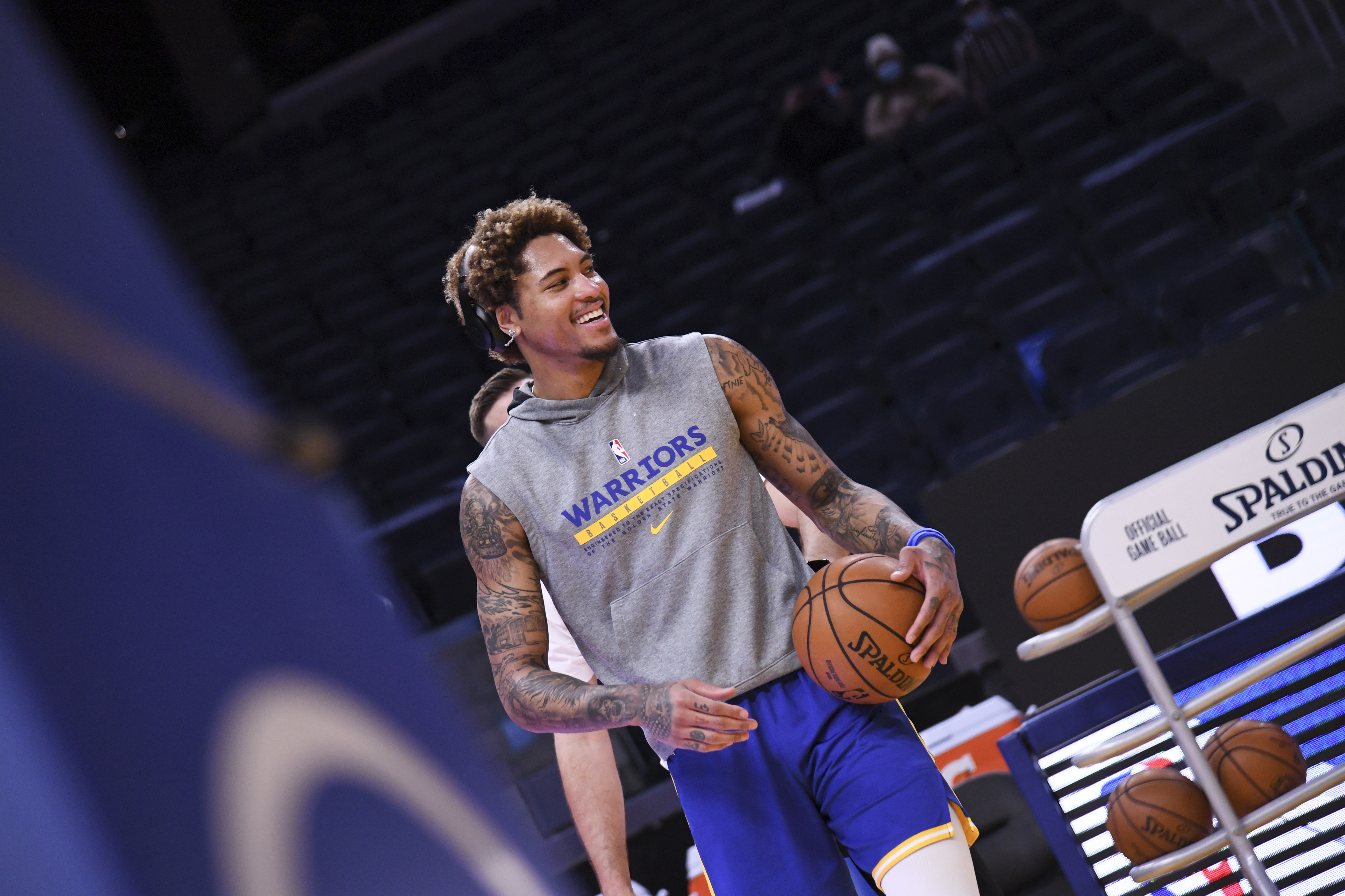 Golden State Warriors guard Kelly Oubre Jr., bottom, reaches for