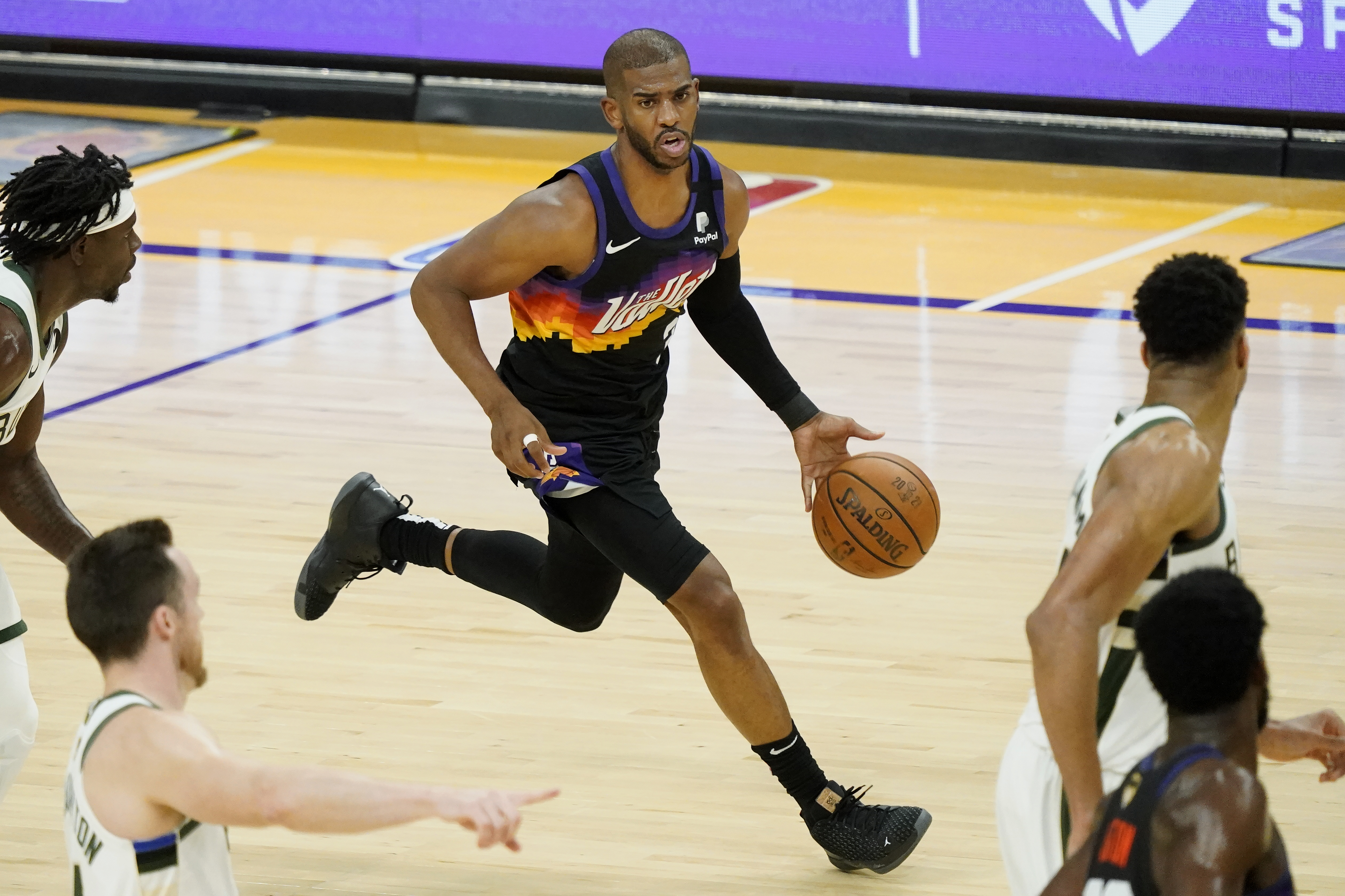 Phoenix Suns guard Chris Paul (3) dribbles against the Milwaukee Bucks during the first half of Game 2 of basketball's NBA Finals, Thursday, July 8, 2021, in Phoenix. (AP Photo/Matt York)