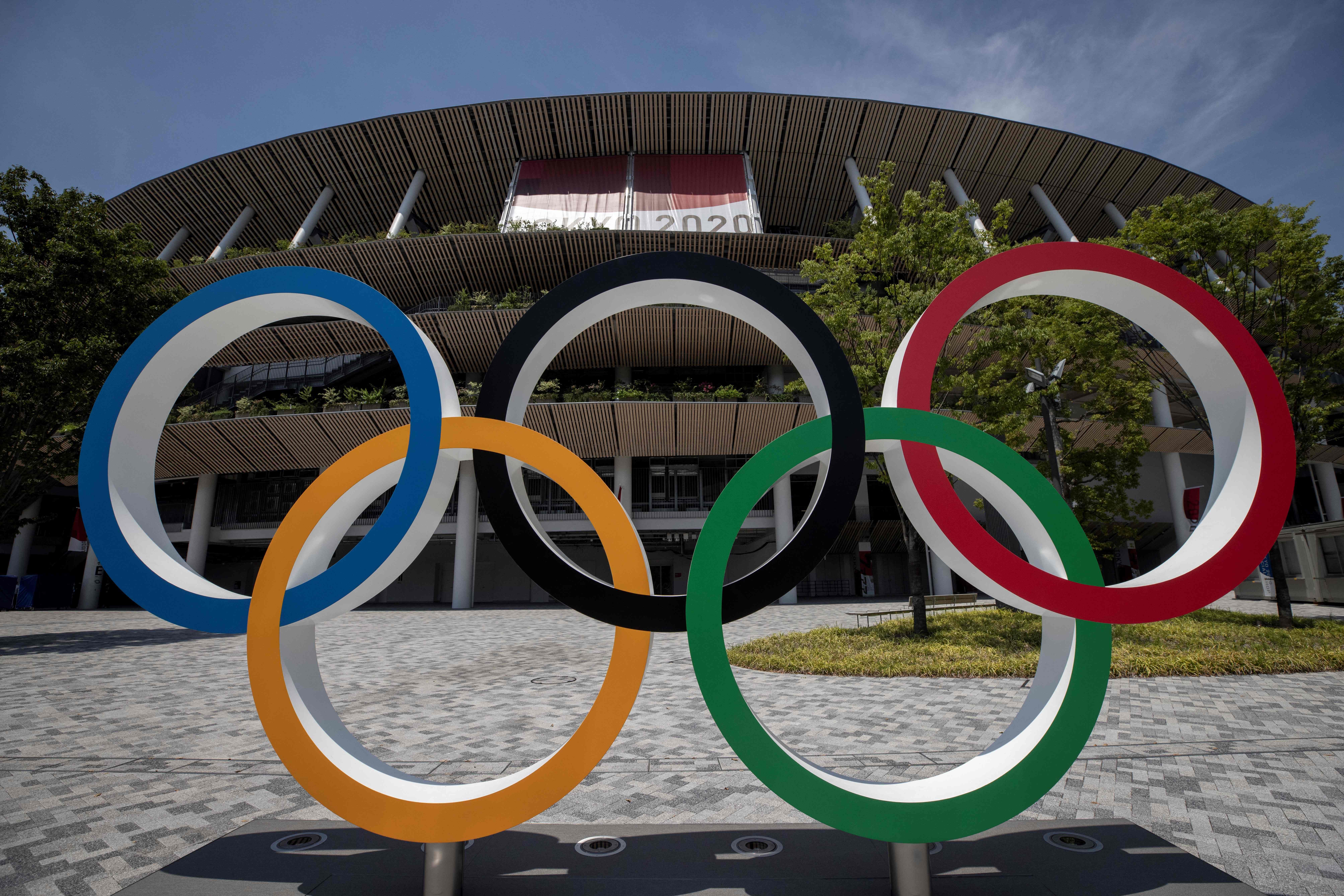 This picture shows the Olympic rings standing in front of the Olympic Stadium in Tokyo on July 20, 2021 ahead of the Tokyo 2020 Olympic Games. (Photo by Behrouz MEHRI / AFP) (Photo by BEHROUZ MEHRI/AFP via Getty Images) This picture shows the Olympic rings standing in front of the Olympic Stadium in Tokyo on July 20, 2021 ahead of the Tokyo 2020 Olympic Games. (Photo by Behrouz MEHRI / AFP) (Photo by BEHROUZ MEHRI/AFP via Getty Images)