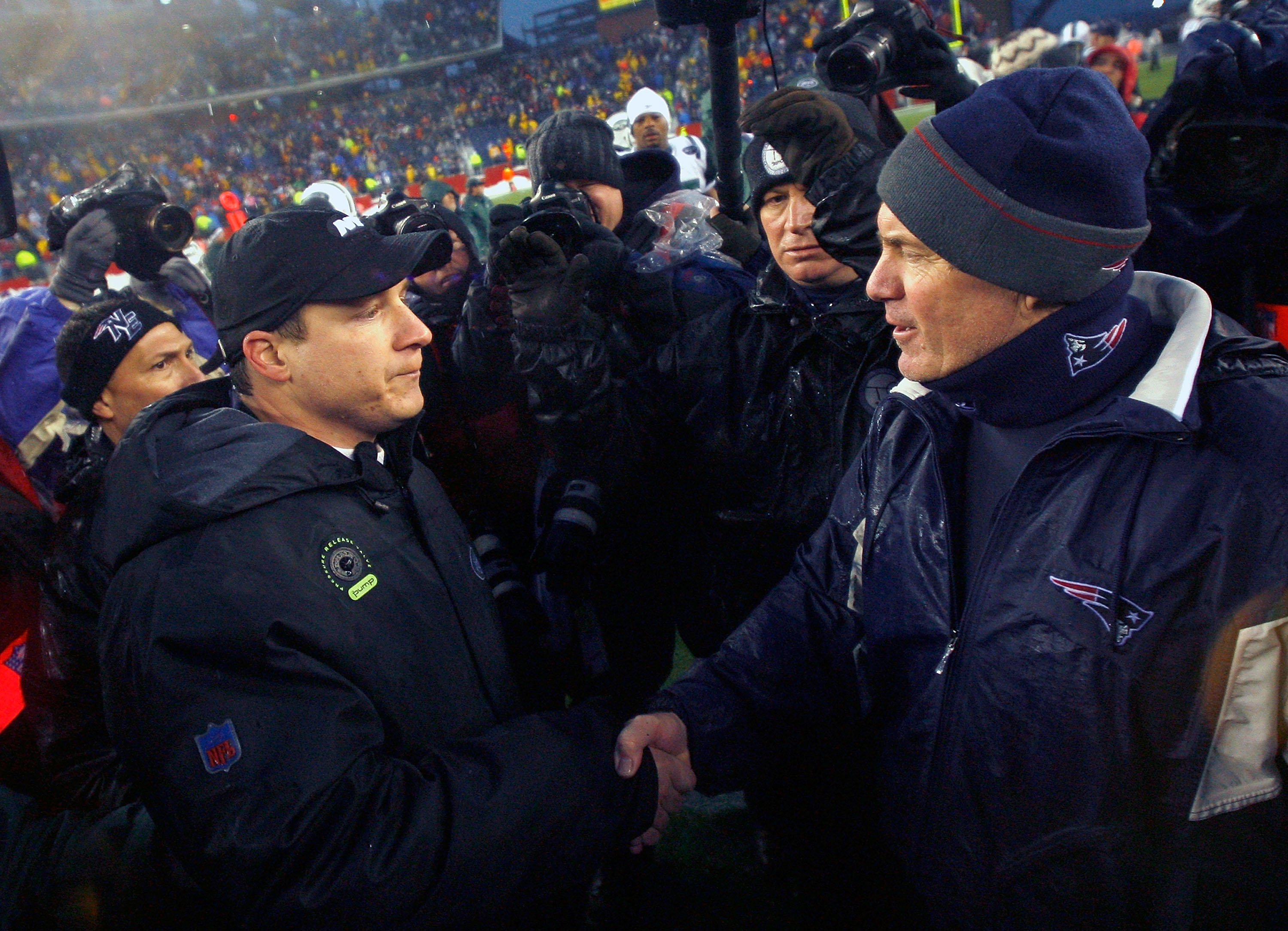 FOXBORO, MA - DECEMBER 16:  Coach Bill Belichick of the New England Patriots shakes hands with coach Eric Mangini of the New York Jets at Gillette Stadium on December 16, 2007 in Foxboro, Massachusetts. The Patriots won 20-10.  (Photo by Jim Rogash/Getty Images)
