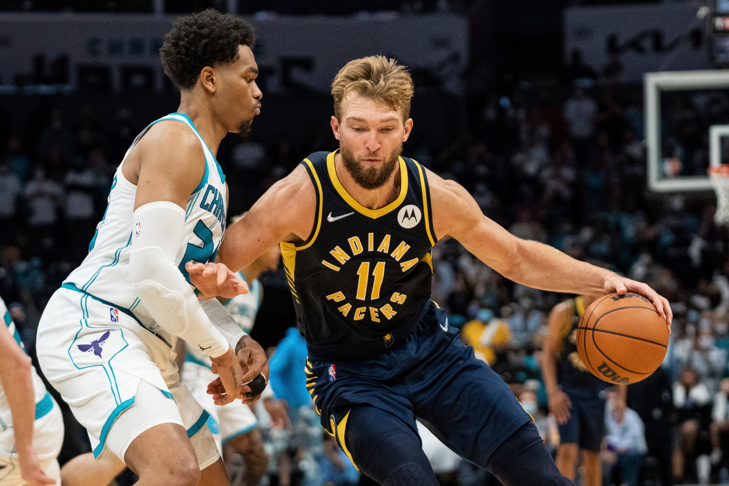Indiana Pacers forward Domantas Sabonis (11) is guarded by Charlotte Hornets forward P.J. Washington (25) during an NBA basketball game in Charlotte, N.C., Wednesday, Oct. 20, 2021. (AP Photo/Jacob Kupferman) Indiana Pacers forward Domantas Sabonis (11) is guarded by Charlotte Hornets forward P.J. Washington (25) during an NBA basketball game in Charlotte, N.C., Wednesday, Oct. 20, 2021. (AP Photo/Jacob Kupferman)