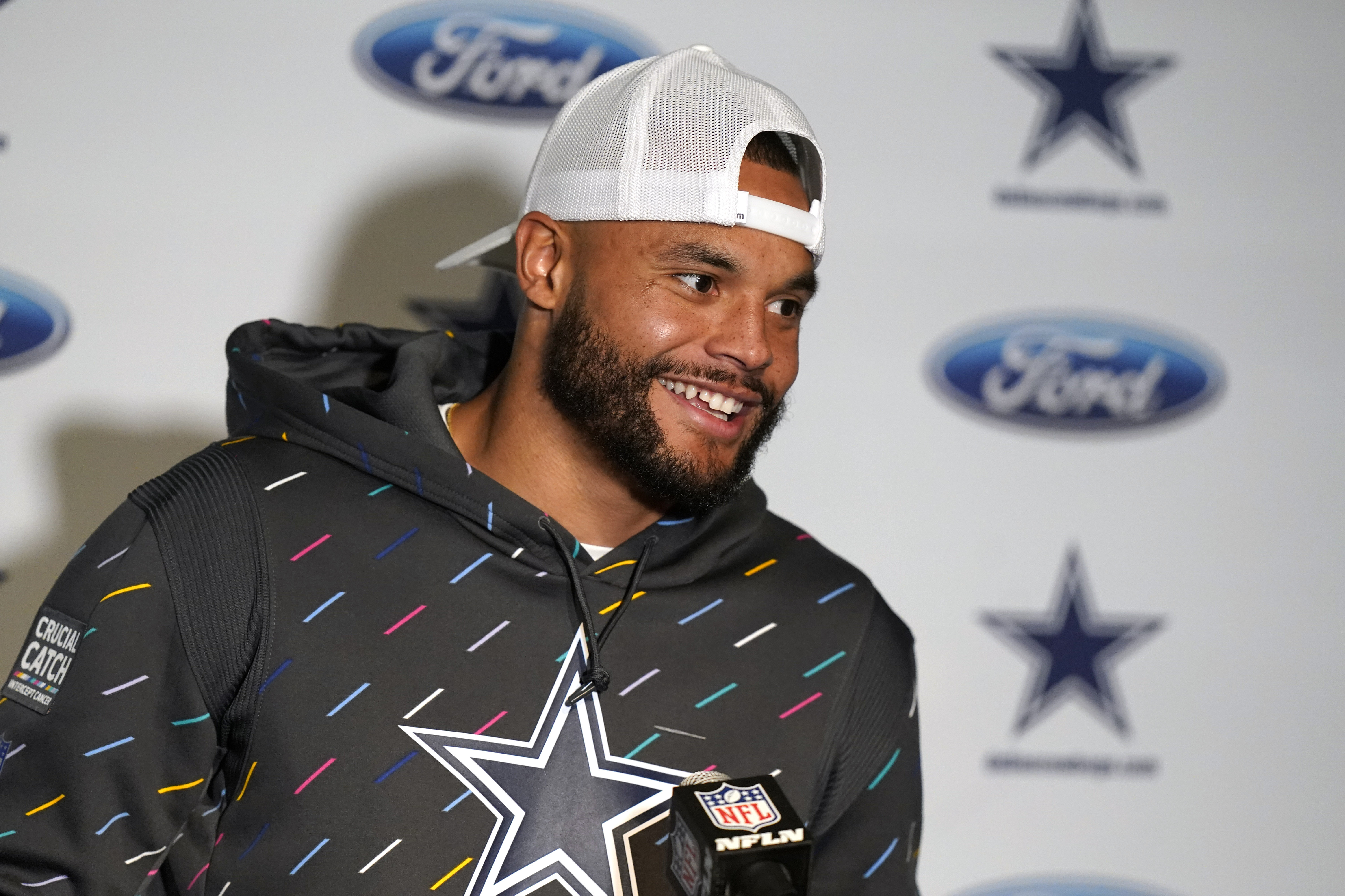 Dallas Cowboys quarterback Dak Prescott wears a Crucial Catch hat