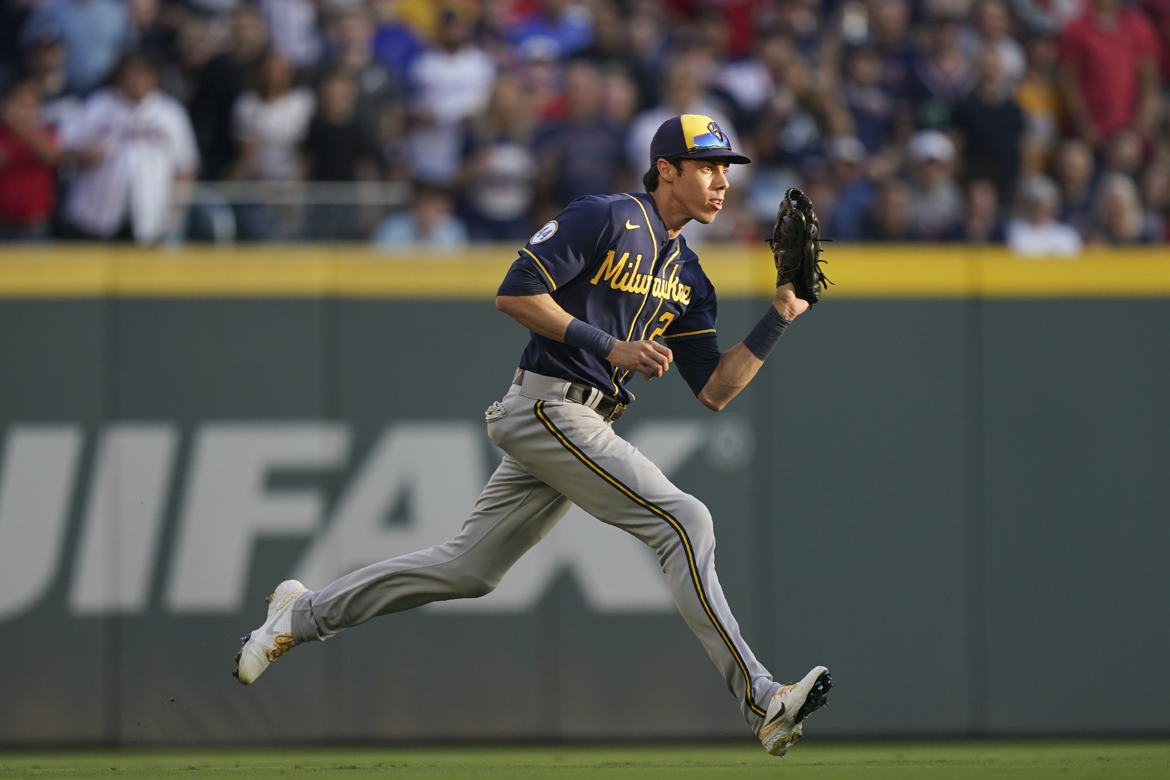 Milwaukee Brewers left fielder Christian Yelich (22) makes a catch during the second inning of Game 4 of a baseball National League Division Series against the Atlanta Braves, Tuesday, Oct. 12, 2021, in Atlanta. (AP Photo/Brynn Anderson)