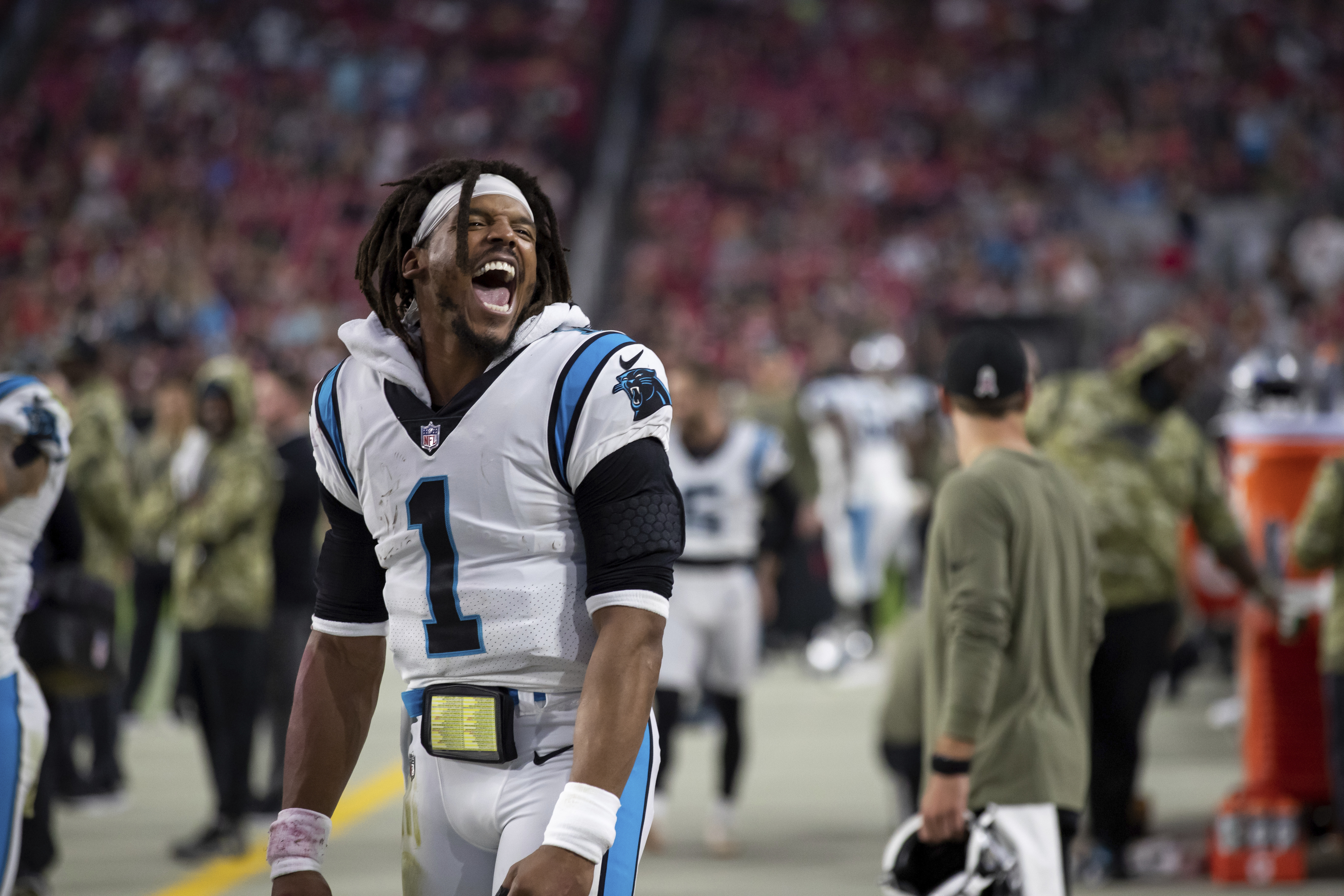 Quarterback (1) Cam Newton of the Carolina Panthers celebrates on the sideline while playing against the Arizona Cardinals in an NFL football game, Sunday, Nov. 14, 2021, in Glendale, Ariz. Panthers defeated the Cardinals 34-10. (AP Photo/Jeff Lewis)