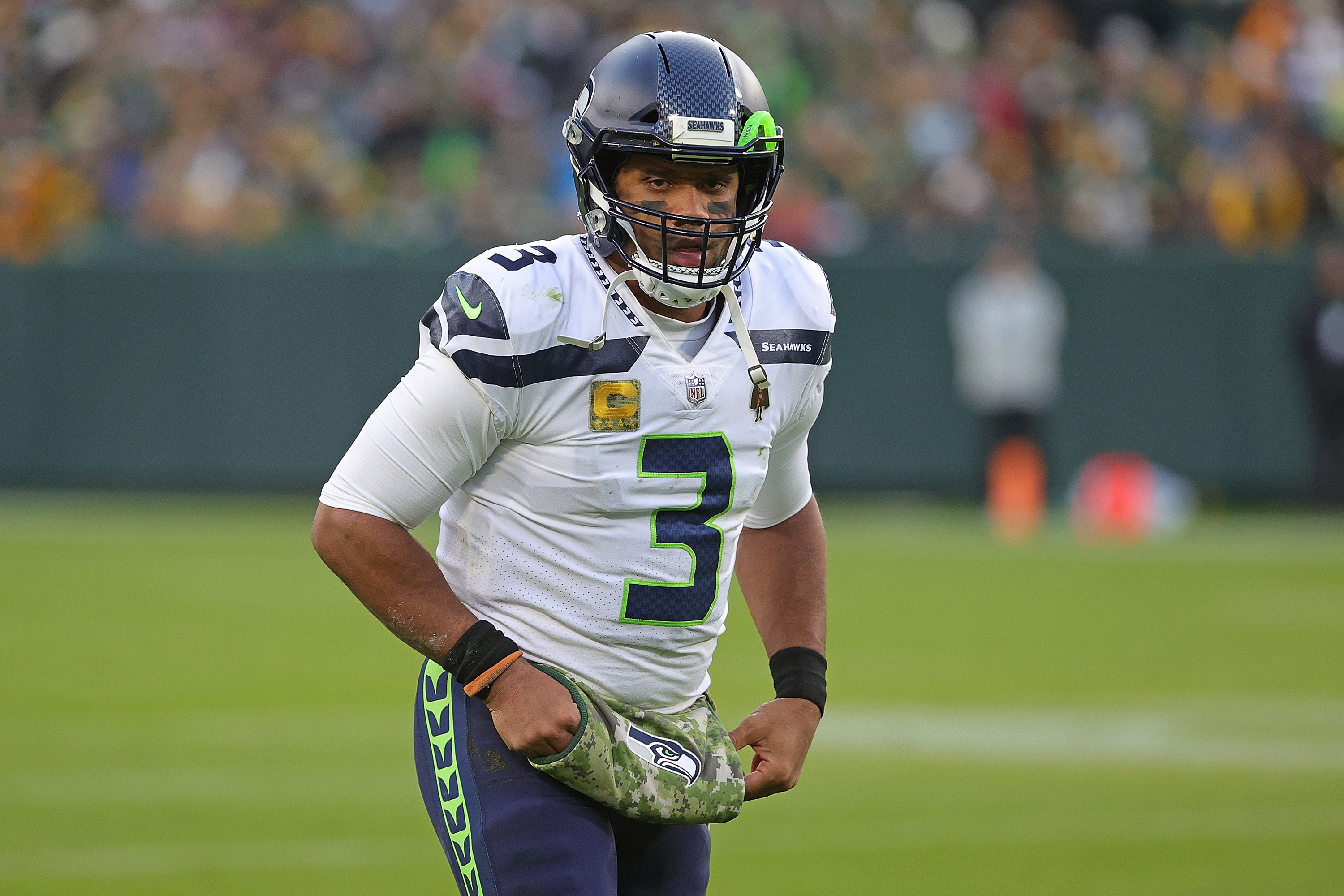 GREEN BAY, WISCONSIN - NOVEMBER 14: Russell Wilson #3 of the Seattle Seahawks walks to the huddle during a game against the Green Bay Packers at Lambeau Field on November 14, 2021 in Green Bay, Wisconsin.  The Packers defeated the Seahawks 17-0.  (Photo by Stacy Revere/Getty Images)