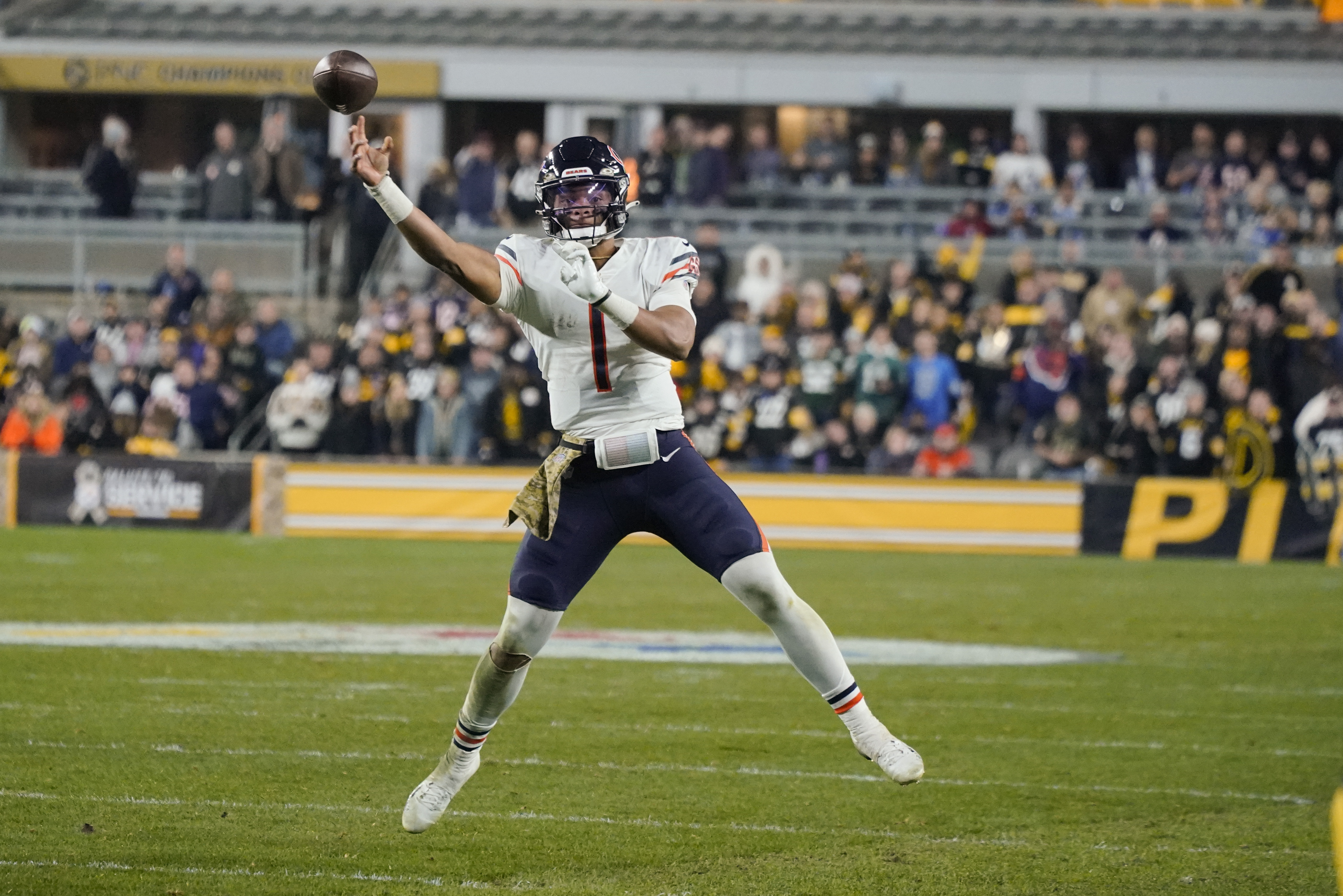 Chicago Bears quarterback Justin Fields (1) passes as he scrambles during the second half of an NFL football game, Monday, Nov. 8, 2021, in Pittsburgh. (AP Photo/Gene J. Puskar)