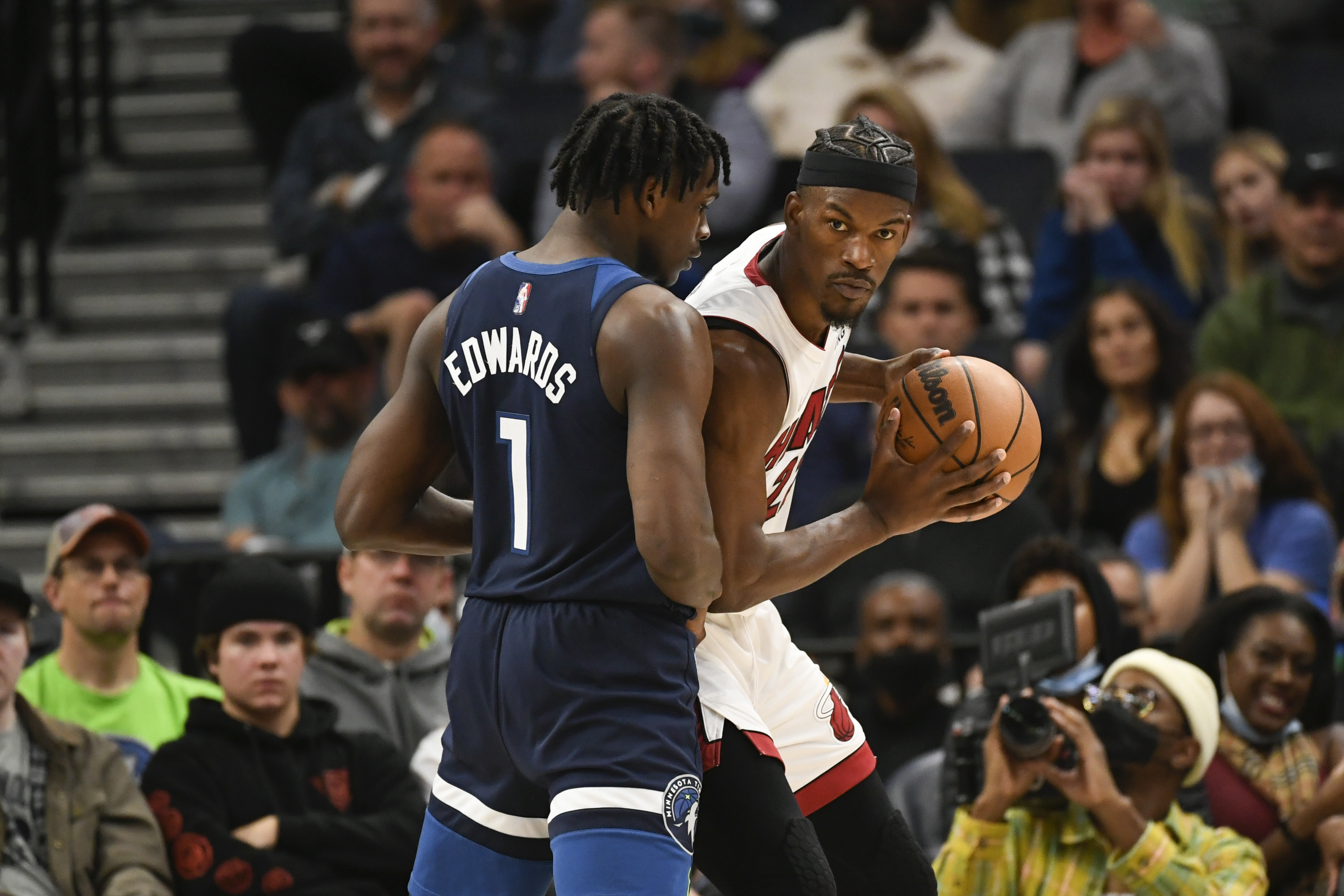 Miami Heat forward Jimmy Butler, right, looks to pass the ball around Minnesota Timberwolves guard Anthony Edwards during the second half of an NBA basketball game Wednesday, Nov. 24, 2021, in Minneapolis. The Timberwolves won 113-101. (AP Photo/Craig Lassig)