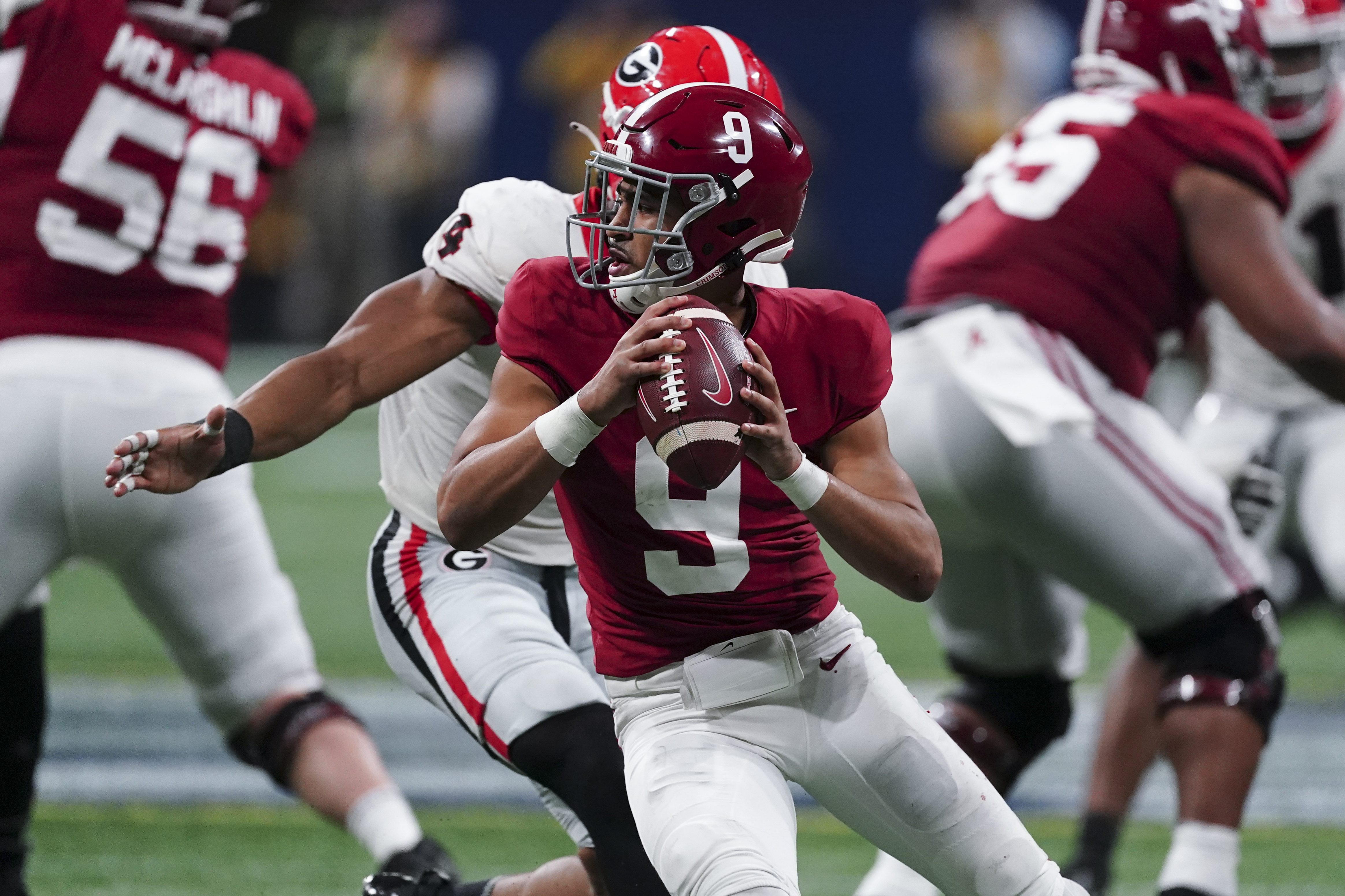 FILE - Alabama quarterback Bryce Young (9) works against Georgia during the second half of the Southeastern Conference championship NCAA college football game Dec. 4, 2021, in Atlanta. Young, Michigan defensive end Aidan Hutchinson, Pittsburgh quarterback Kenny Pickett and Ohio State quarterback C.J. Stroud are the finalists for the Heisman Trophy. (AP Photo/John Bazemore, File)