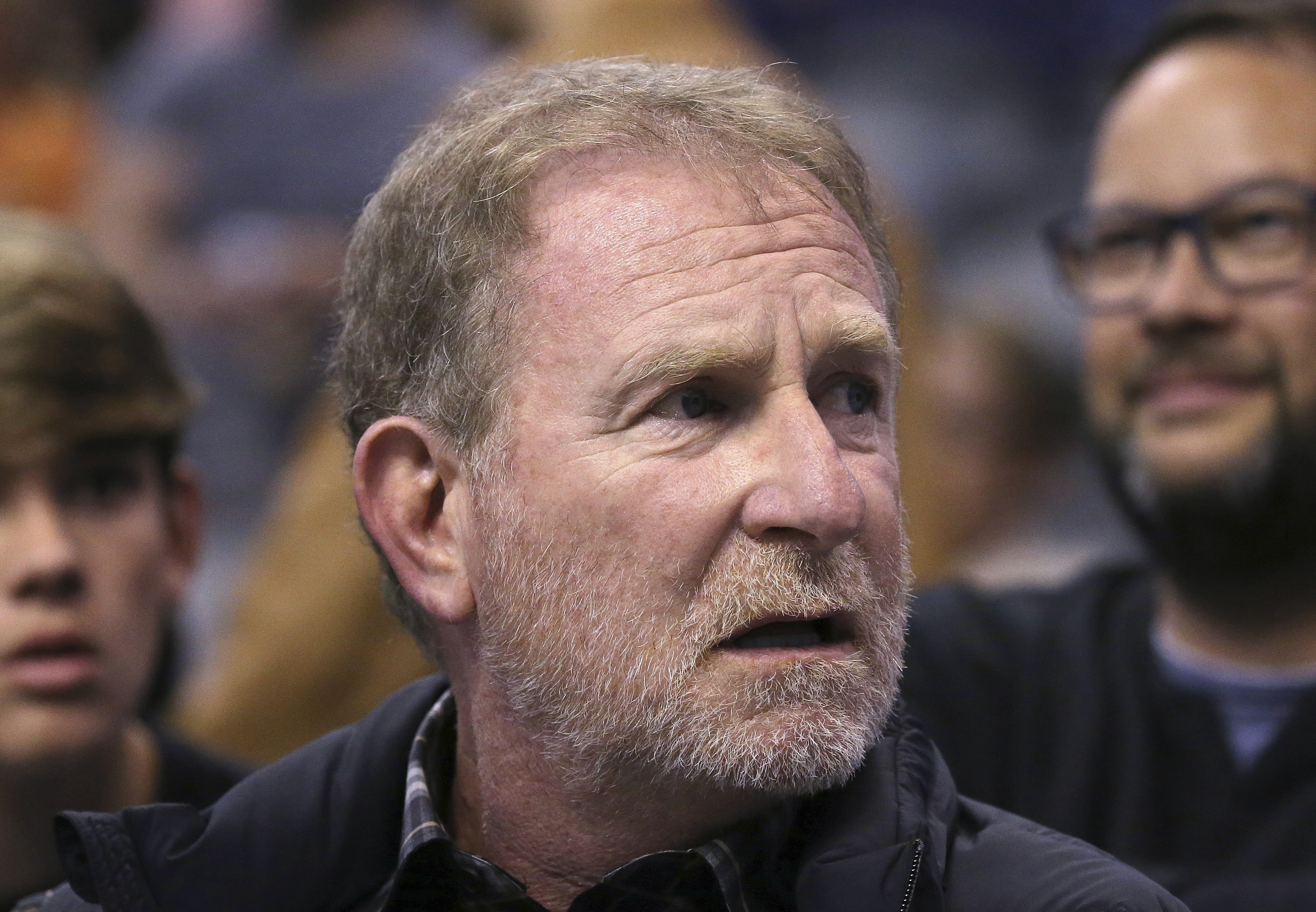 FILE - In this Dec. 11, 2019, file photo, Phoenix Suns owner Robert Sarver watches the team play against the Memphis Grizzlies during the second half of an NBA basketball game in Phoenix. The Suns released a statement regarding a potential media investigation into the workplace culture of the franchise, denying that the organization or Sarver has a history of racism or sexism. The statement sent Friday, Oct. 22, 2021, said the organization is aware that ESPN is working on a story accusing the organization of misconduct on a “variety of topics.” The Suns responded by saying they were “completely baseless claims” and “documentary evidence in our possession and eyewitness accounts directly contradict the reporter’s accusations, and we are preparing our response to his questions.” (AP Photo/Ross D. Franklin, File)