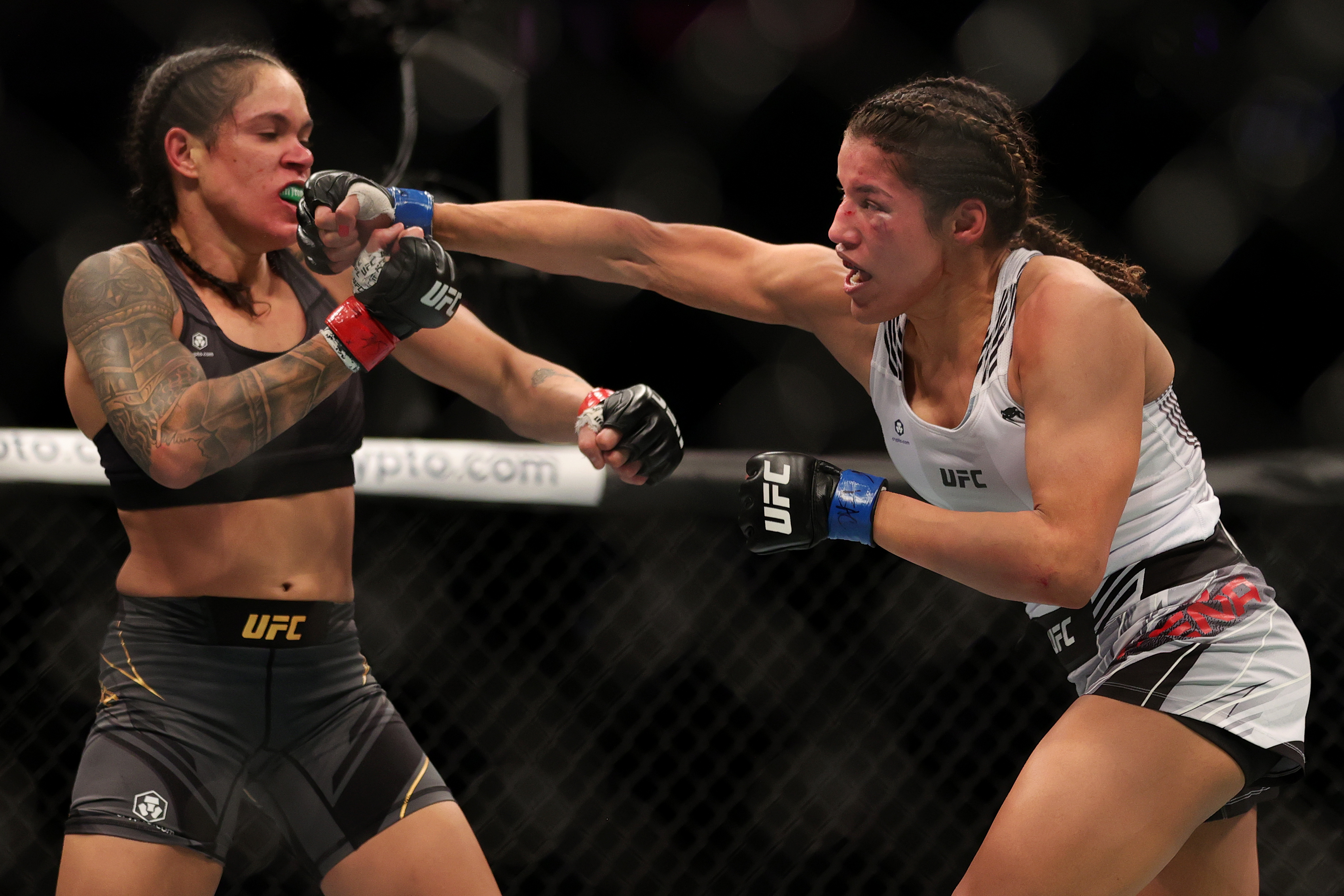 LAS VEGAS, NEVADA - DECEMBER 11: Julianna Pena (R) punches Amanda Nunes of Brazil in their women's bantamweight title fight during the UFC 269 event at T-Mobile Arena on December 11, 2021 in Las Vegas, Nevada. (Photo by Carmen Mandato/Getty Images)