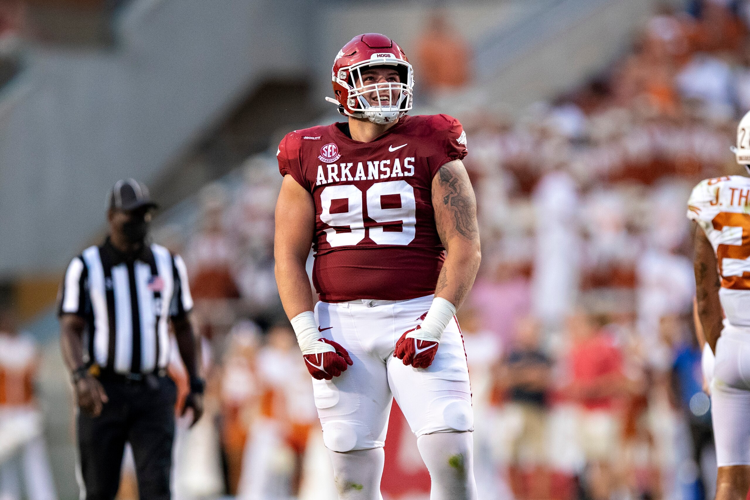 FAYETTEVILLE, AR - SEPTEMBER 11: John Ridgeway #99 of the Arkansas Razorbacks reacts while watching a replay on the scoreboard during a game against the Texas Longhorns at Donald W. Reynolds Stadium on September 11, 2021 in Fayetteville, Arkansas. The Razorbacks defeated the Longhorns 21-40. (Photo by Wesley Hitt/Getty Images) FAYETTEVILLE, AR - SEPTEMBER 11: John Ridgeway #99 of the Arkansas Razorbacks reacts while watching a replay on the scoreboard during a game against the Texas Longhorns at Donald W. Reynolds Stadium on September 11, 2021 in Fayetteville, Arkansas. The Razorbacks defeated the Longhorns 21-40. (Photo by Wesley Hitt/Getty Images)
