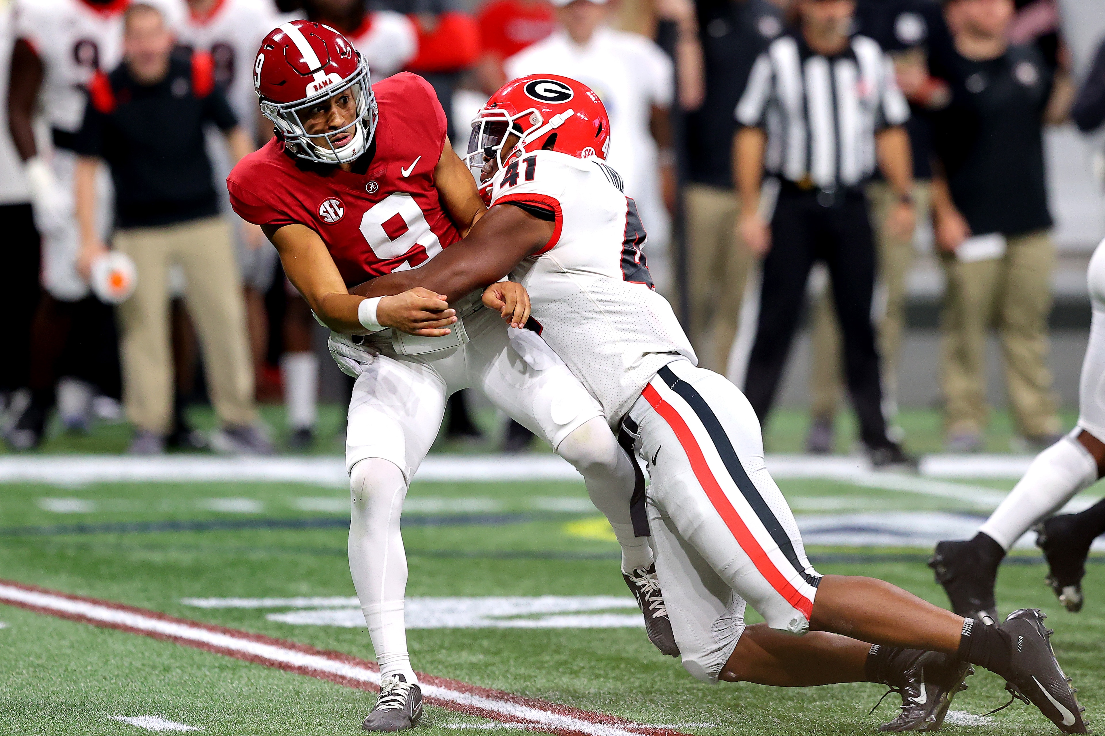ATLANTA, GEORGIA - DECEMBER 04: Bryce Young #9 of the Alabama Crimson Tide is tackled by Channing Tindall #41 of the Georgia Bulldogs in the second quarter of the SEC Championship game at Mercedes-Benz Stadium on December 04, 2021 in Atlanta, Georgia. (Photo by Kevin C. Cox/Getty Images)