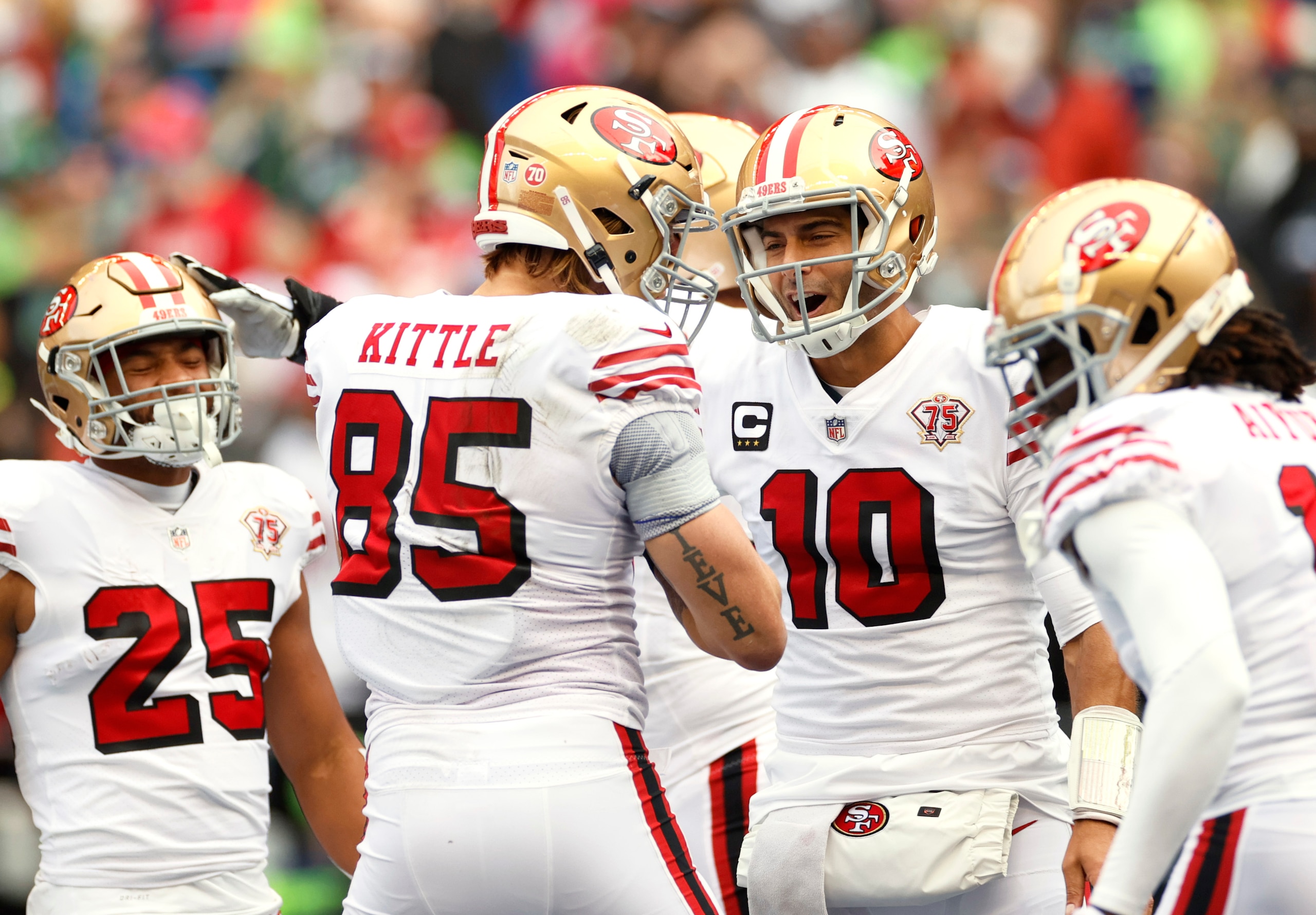 SEATTLE, WASHINGTON - DECEMBER 05: George Kittle #85 of the San Francisco 49ers celebrates with Jimmy Garoppolo #10 after catching the ball for a touchdown during the first quarter against the Seattle Seahawks at Lumen Field on December 05, 2021 in Seattle, Washington. (Photo by Steph Chambers/Getty Images)