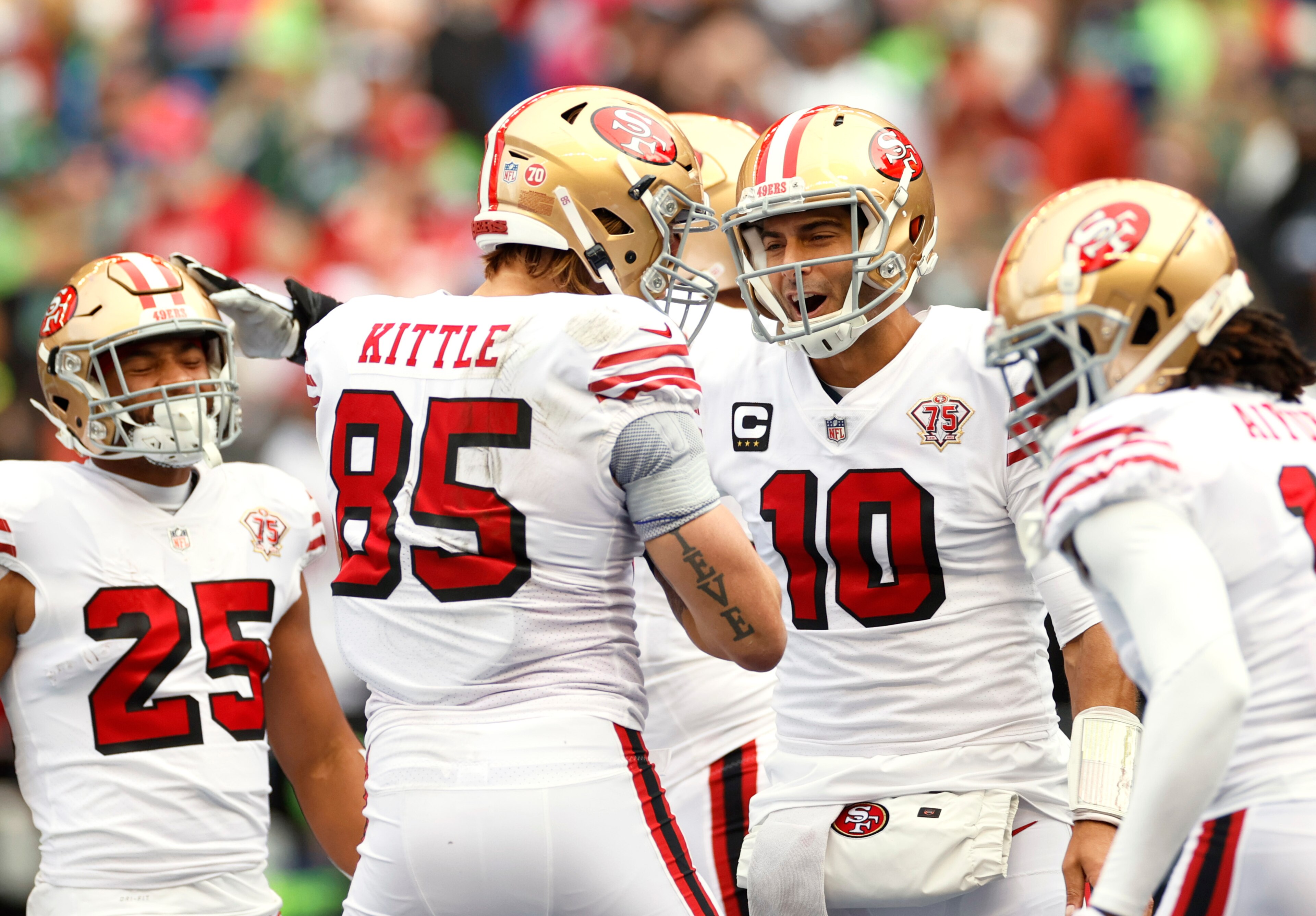 SEATTLE, WASHINGTON - DECEMBER 05: George Kittle #85 of the San Francisco 49ers celebrates with Jimmy Garoppolo #10 after catching the ball for a touchdown during the first quarter against the Seattle Seahawks at Lumen Field on December 05, 2021 in Seattle, Washington. (Photo by Steph Chambers/Getty Images)