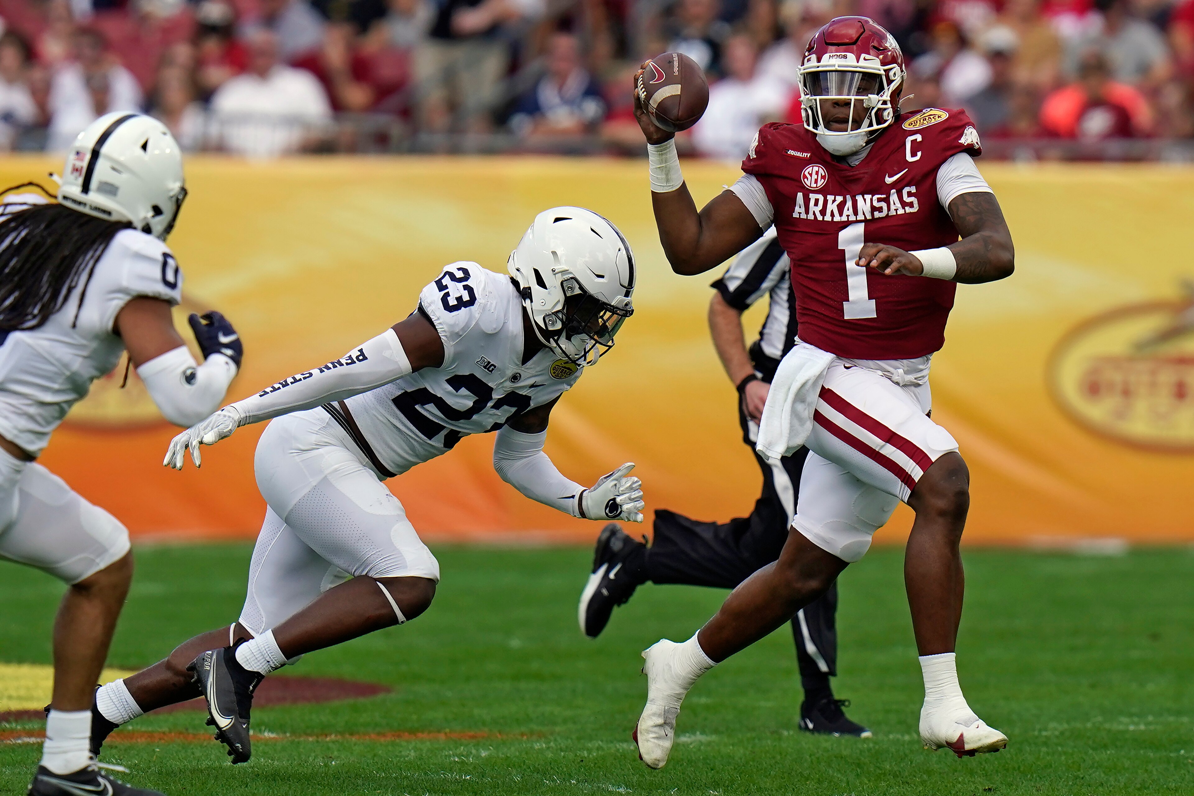 Arkansas quarterback KJ Jefferson (1) eludes Penn State linebacker Curtis Jacobs (23) during the first half of the Outback Bowl NCAA college football game Saturday, Jan. 1, 2022, in Tampa, Fla. (AP Photo/Chris O'Meara) Arkansas quarterback KJ Jefferson (1) eludes Penn State linebacker Curtis Jacobs (23) during the first half of the Outback Bowl NCAA college football game Saturday, Jan. 1, 2022, in Tampa, Fla. (AP Photo/Chris O'Meara)