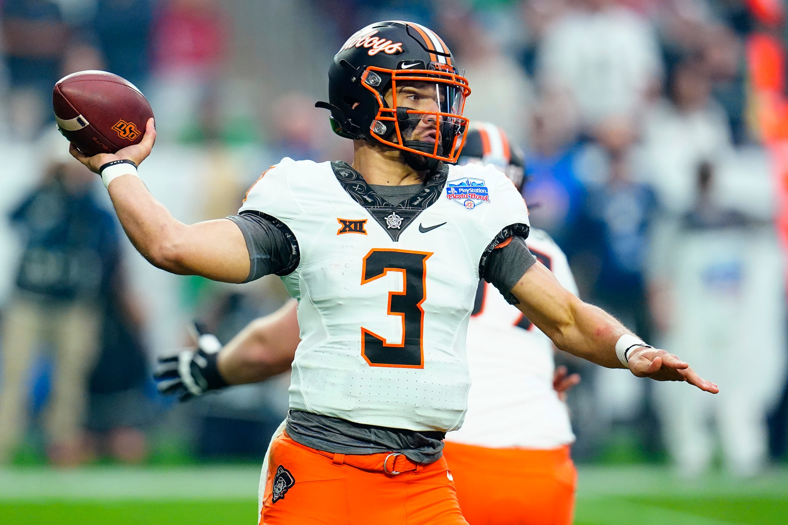 Oklahoma State quarterback Spencer Sanders (3) throws against Notre Dame during the first half of the Fiesta Bowl NCAA college football game, Saturday, Jan. 1, 2022, in Glendale, Ariz. (AP Photo/Ross D. Franklin)