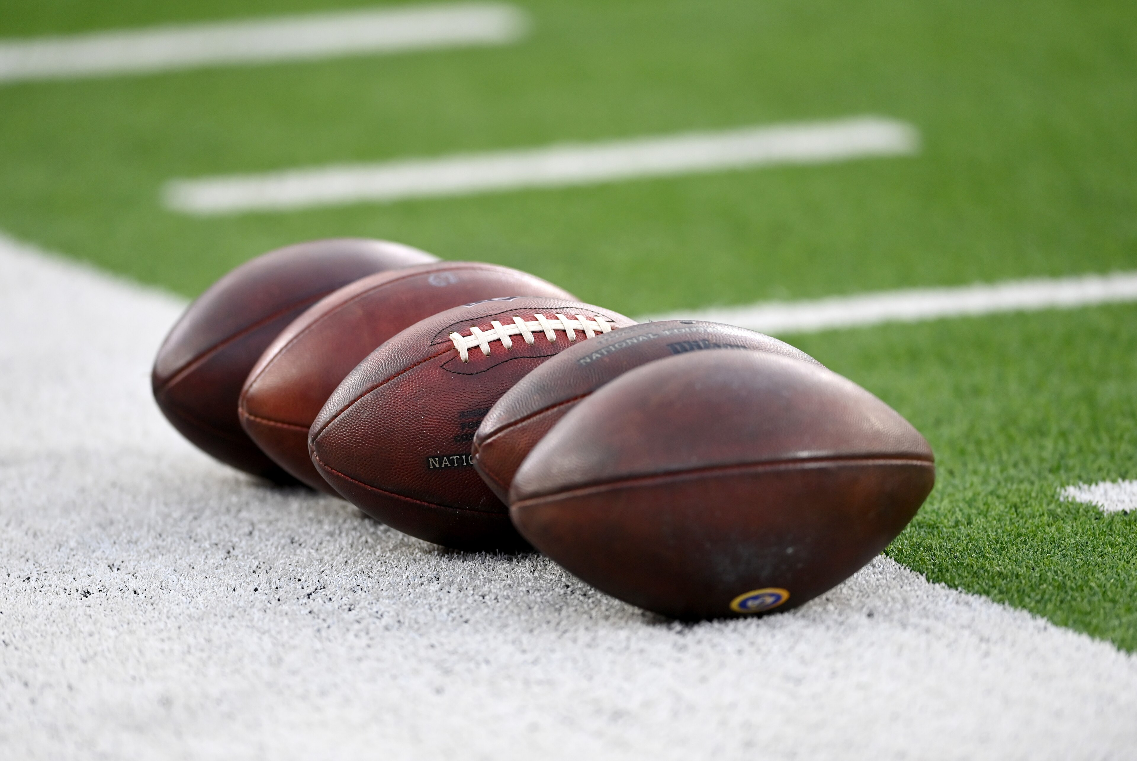 INGLEWOOD, CA - DECEMBER 21: NFL footballs are lined up on the field before the game between the Los Angeles Rams and the Seattle Seahawks at SoFi Stadium on December 19, 2021 in Inglewood, California. (Photo by Jayne Kamin-Oncea/Getty Images) INGLEWOOD, CA - DECEMBER 21: NFL footballs are lined up on the field before the game between the Los Angeles Rams and the Seattle Seahawks at SoFi Stadium on December 19, 2021 in Inglewood, California. (Photo by Jayne Kamin-Oncea/Getty Images)