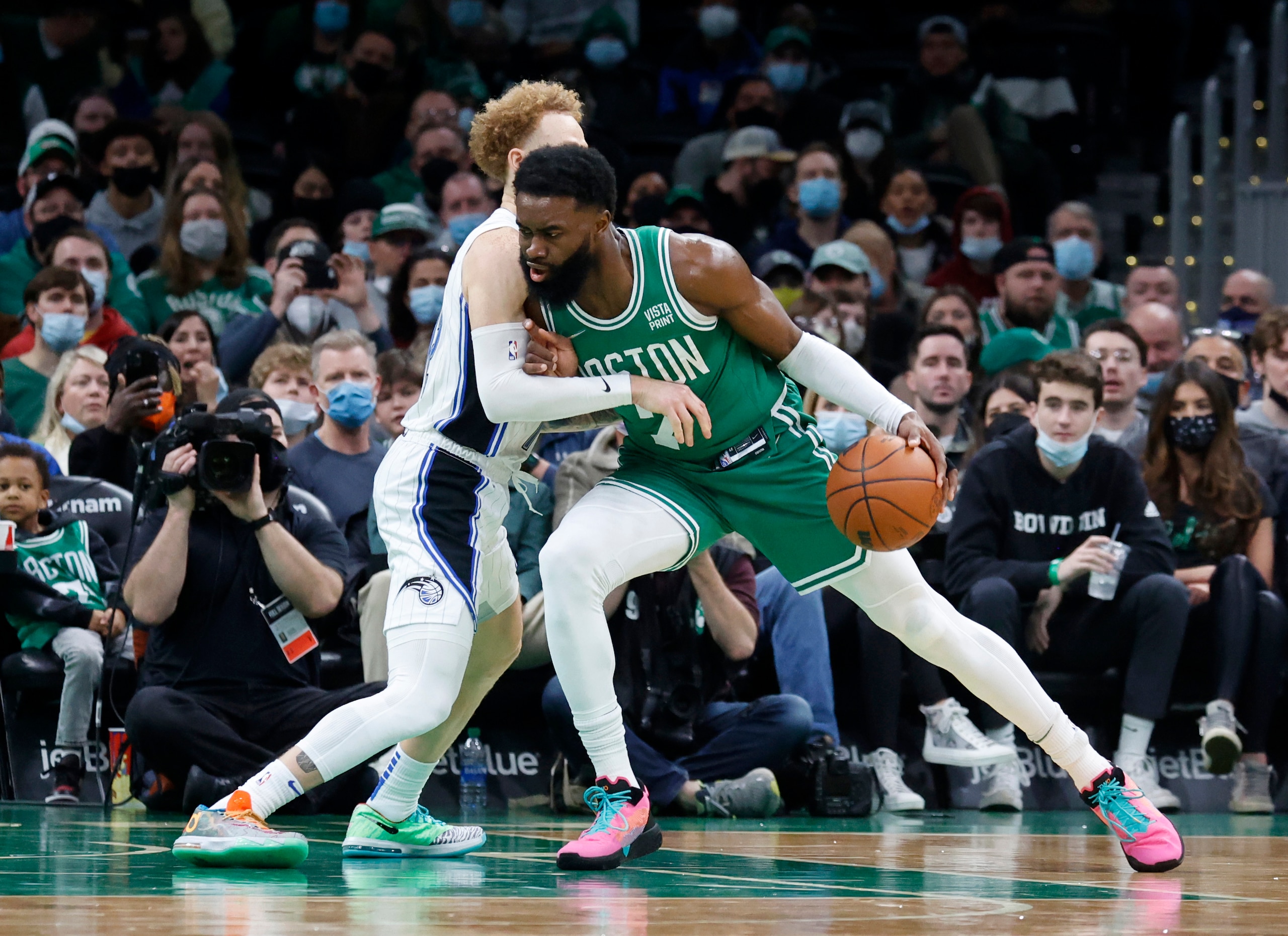 Boston Celtics guard Jaylen Brown (7) drives against Orlando Magic guard Hassani Gravett (12) during the first half of an NBA basketball game, Sunday, Jan. 2, 2022, in Boston. (AP Photo/Mary Schwalm) Boston Celtics guard Jaylen Brown (7) drives against Orlando Magic guard Hassani Gravett (12) during the first half of an NBA basketball game, Sunday, Jan. 2, 2022, in Boston. (AP Photo/Mary Schwalm)