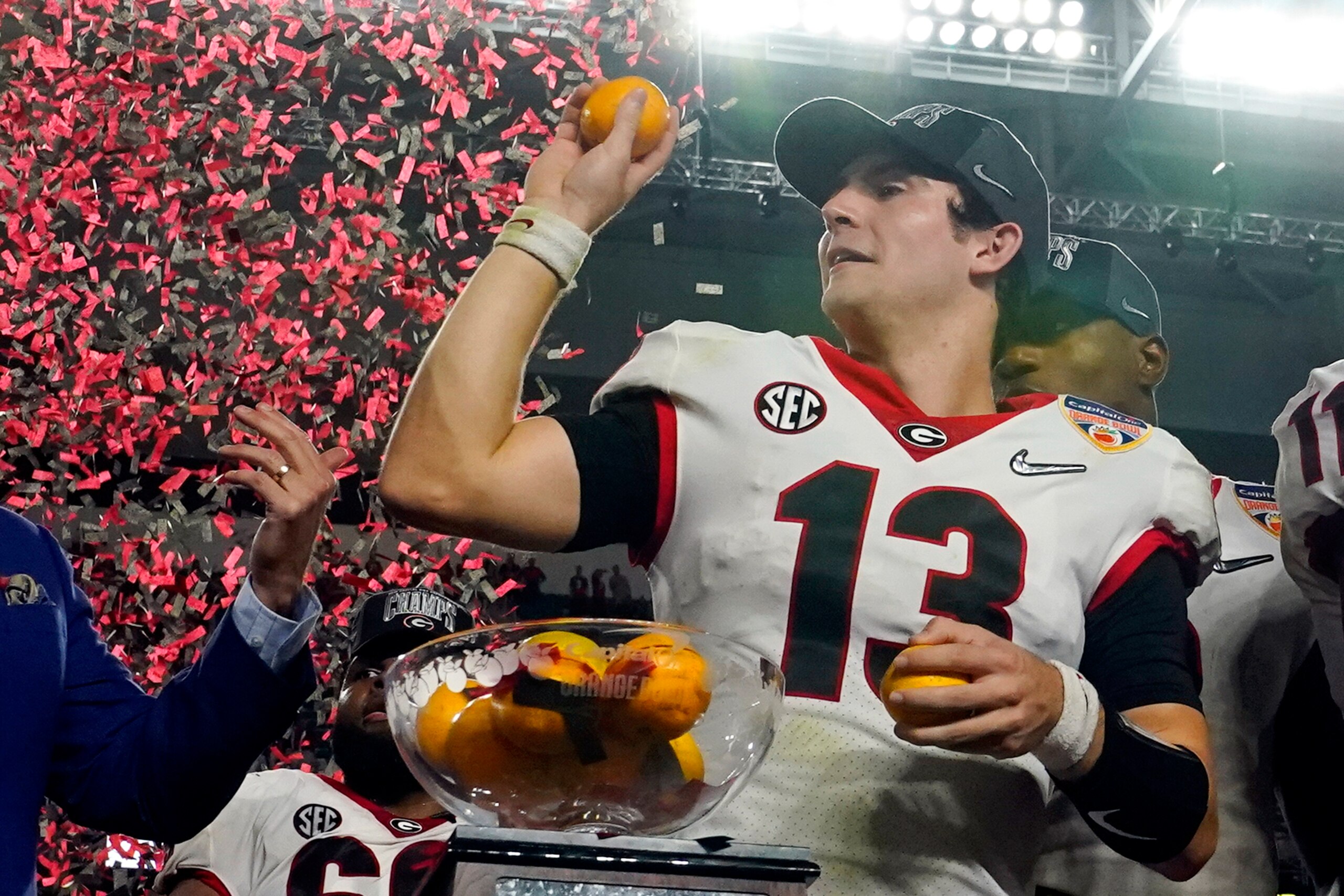 Georgia quarterback Stetson Bennett tosses oranges after their win against Michigan in the Orange Bowl NCAA College Football Playoff semifinal game, Friday, Dec. 31, 2021, in Miami Gardens, Fla. Georgia won 34-11.(AP Photo/Lynne Sladky) Georgia quarterback Stetson Bennett tosses oranges after their win against Michigan in the Orange Bowl NCAA College Football Playoff semifinal game, Friday, Dec. 31, 2021, in Miami Gardens, Fla. Georgia won 34-11.(AP Photo/Lynne Sladky)
