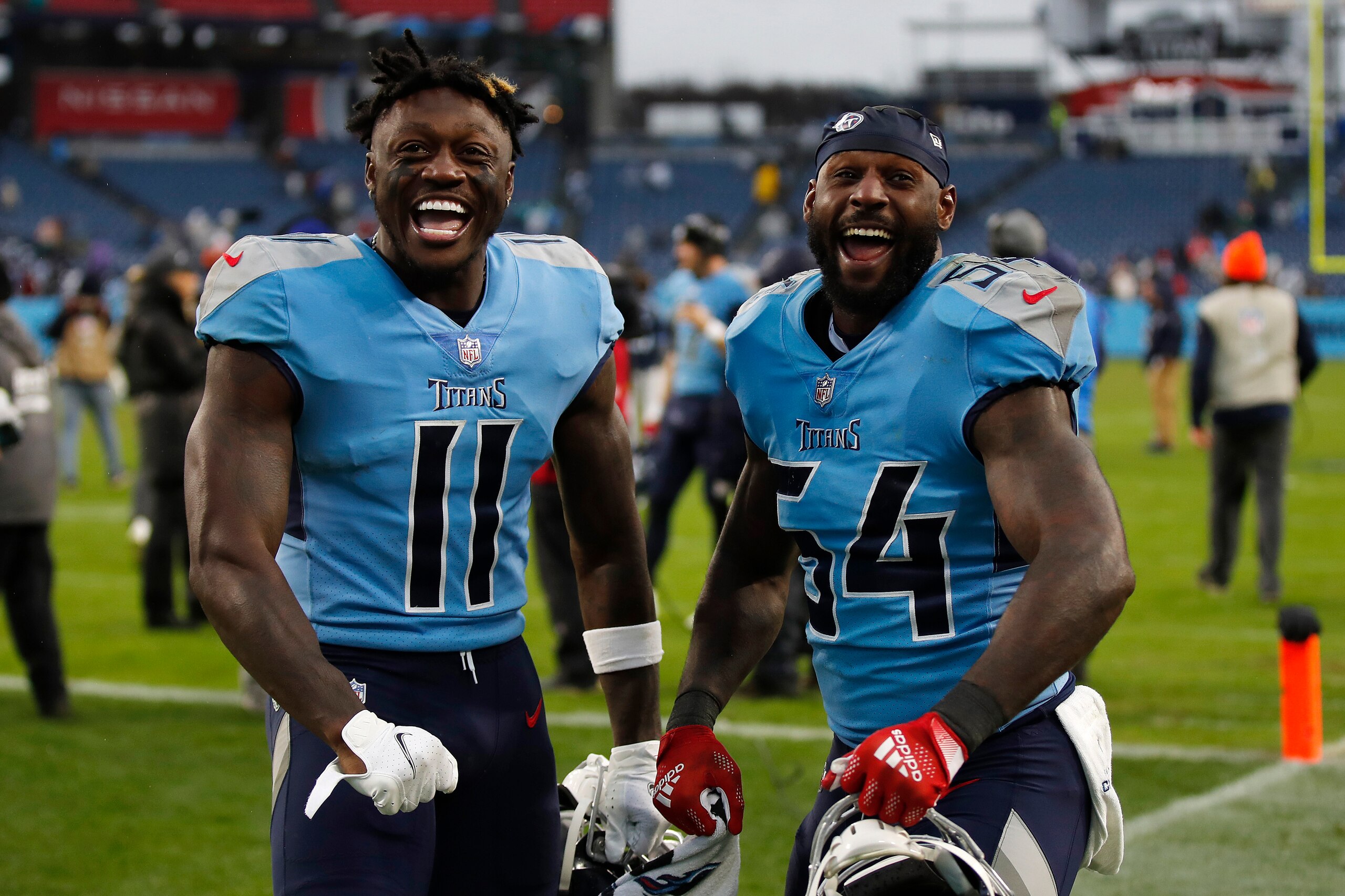 NASHVILLE, TENNESSEE - JANUARY 02: A.J. Brown #11 and Rashaan Evans #54 of the Tennessee Titans celebrate after defeating the Miami Dolphins 34-3 at Nissan Stadium on January 02, 2022 in Nashville, Tennessee. (Photo by Wesley Hitt/Getty Images)