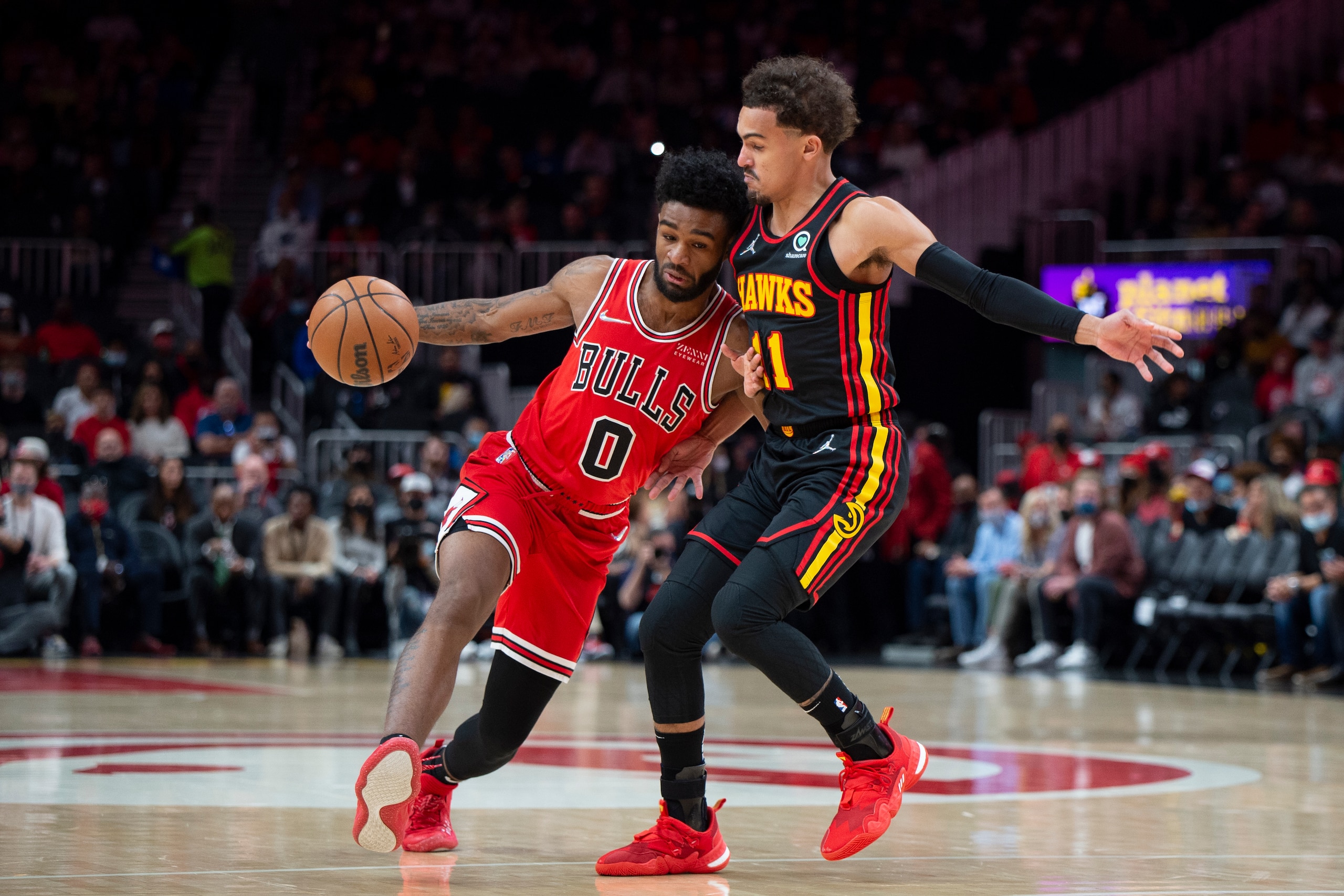 Atlanta Hawks guard Trae Young (11) defends against Chicago Bulls guard Coby White (0) during the second half of an NBA basketball game Monday, Dec. 27, 2021, in Atlanta. (AP Photo/Hakim Wright Sr.)