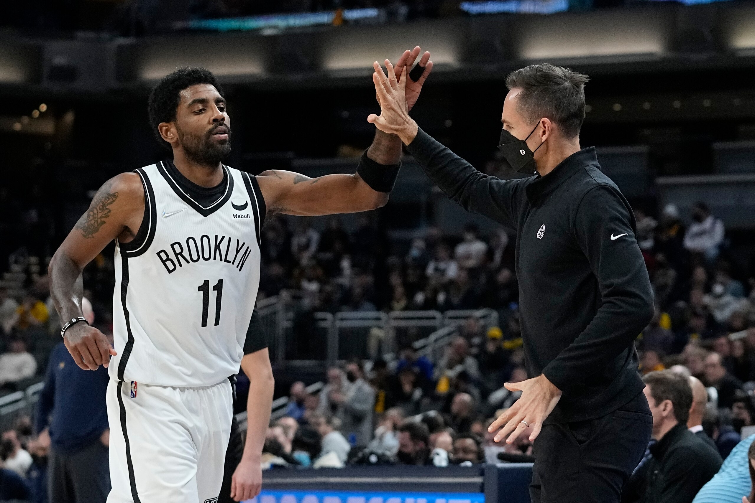 Brooklyn Nets coach Steve Nash reacts with Kyrie Irving during the second half of the team's NBA basketball game against the Indiana Pacers, Wednesday, Jan. 5, 2022, in Indianapolis. (AP Photo/Darron Cummings)